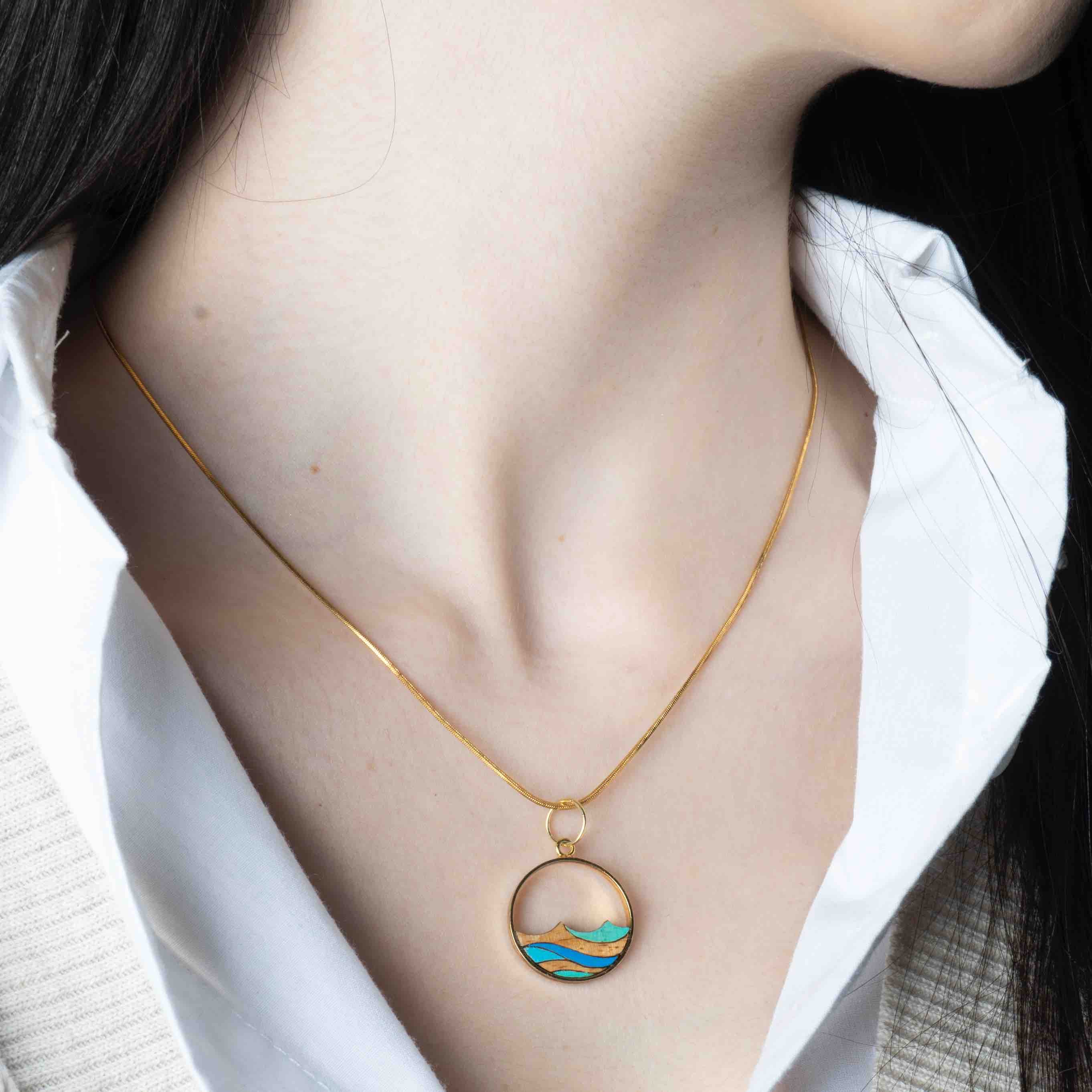 Ocean Recycled Wood Gold Necklace featuring a unique wooden pendant and 24K gold plated chain, elegantly displayed in a luxury gift box.