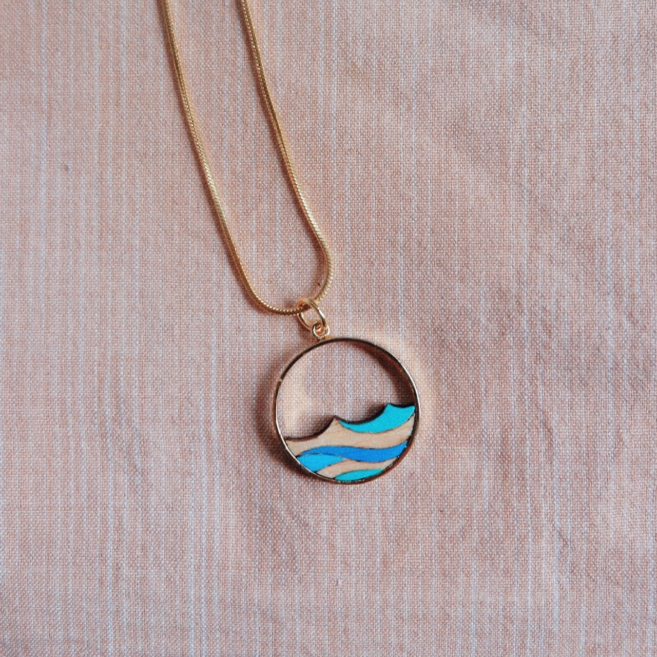 Ocean Recycled Wood Gold Necklace featuring a unique wooden pendant and 24K gold plated chain, elegantly displayed in a luxury gift box.