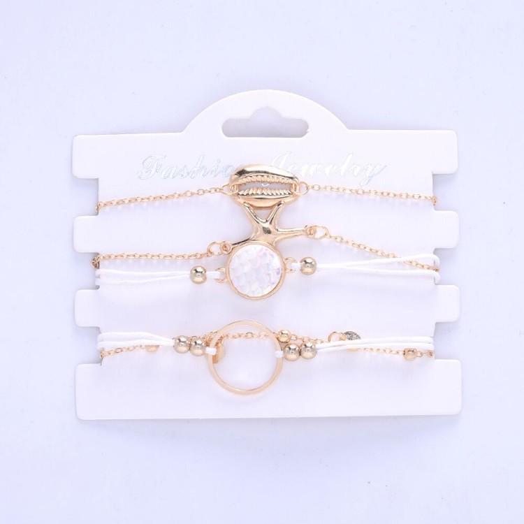 Oceanic Inspired Seashell 5 Piece Bracelet Set featuring 14K gold plating and a seashell pendant, elegantly designed in Italy.