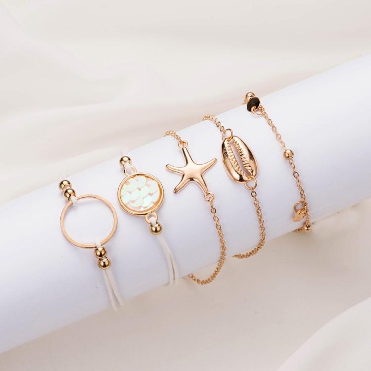 Oceanic Inspired Seashell 5 Piece Bracelet Set featuring 14K gold plating and a seashell pendant, elegantly designed in Italy.