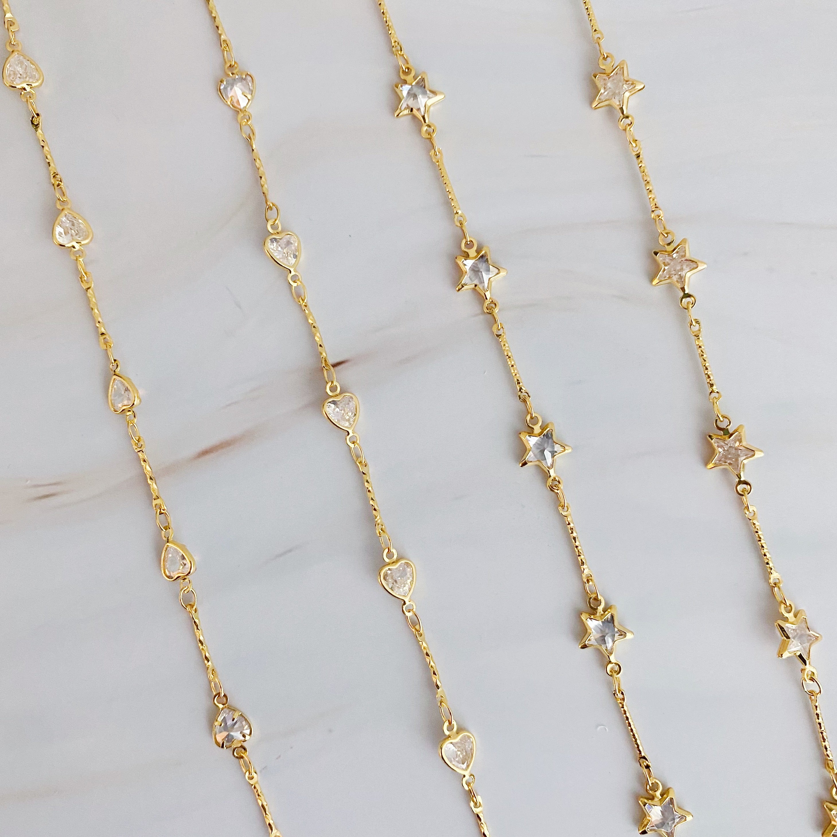 Oh My Shaped Sparkling Necklace featuring a star or heart design with cubic zirconia on a gold plated chain.