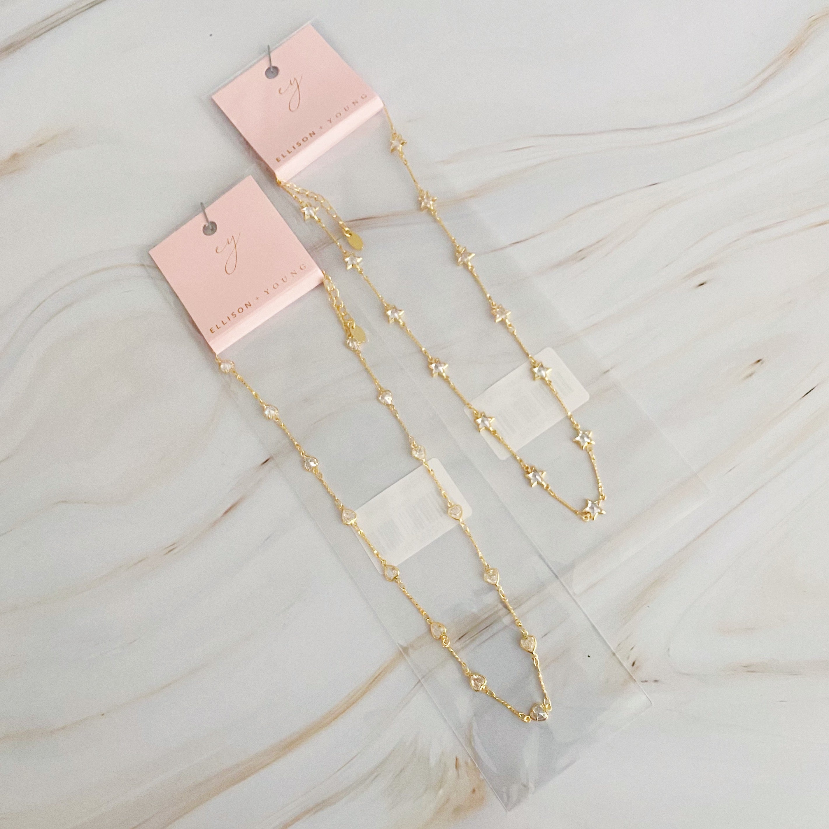 Oh My Shaped Sparkling Necklace featuring a star or heart design with cubic zirconia on a gold plated chain.