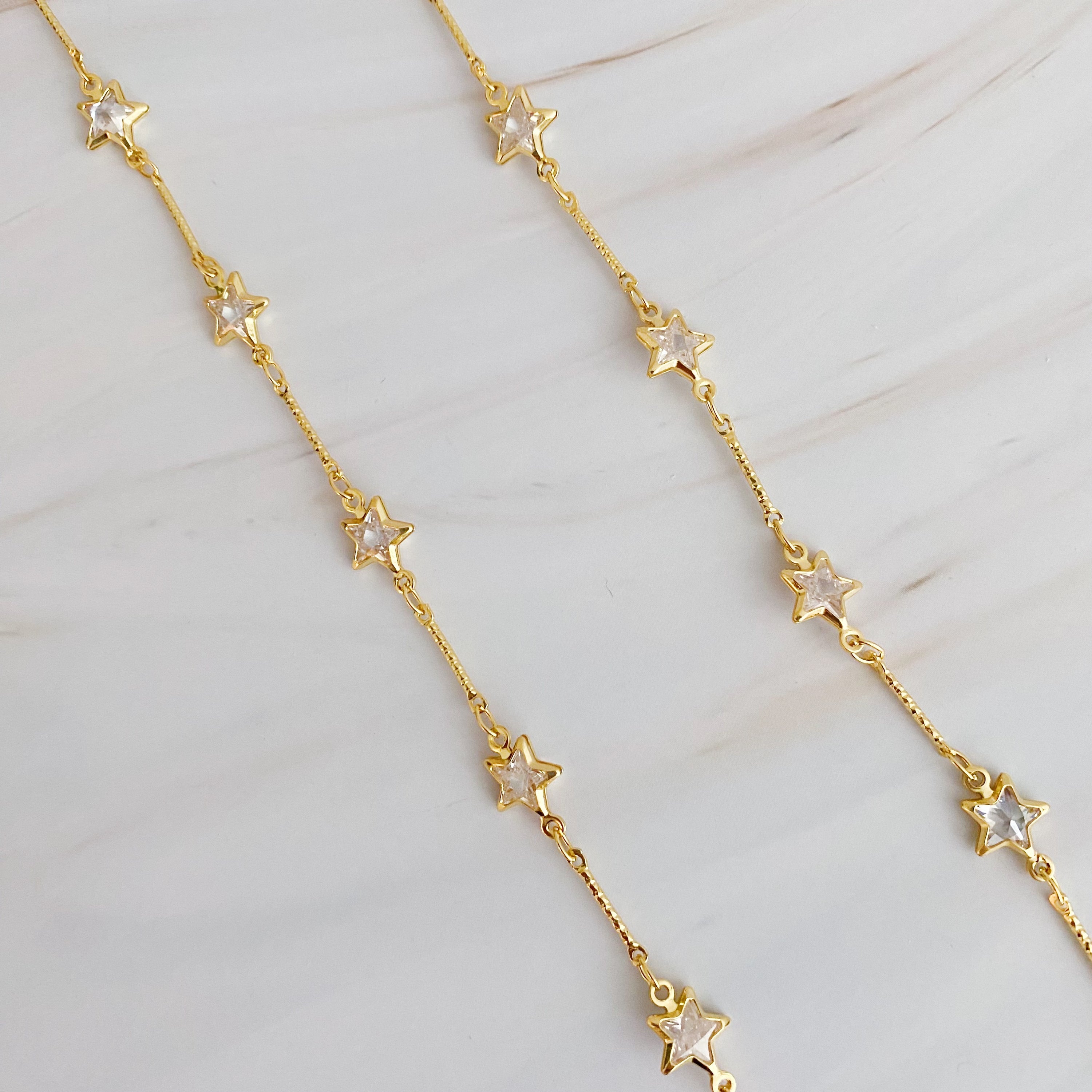 Oh My Shaped Sparkling Necklace featuring a star or heart design with cubic zirconia on a gold plated chain.