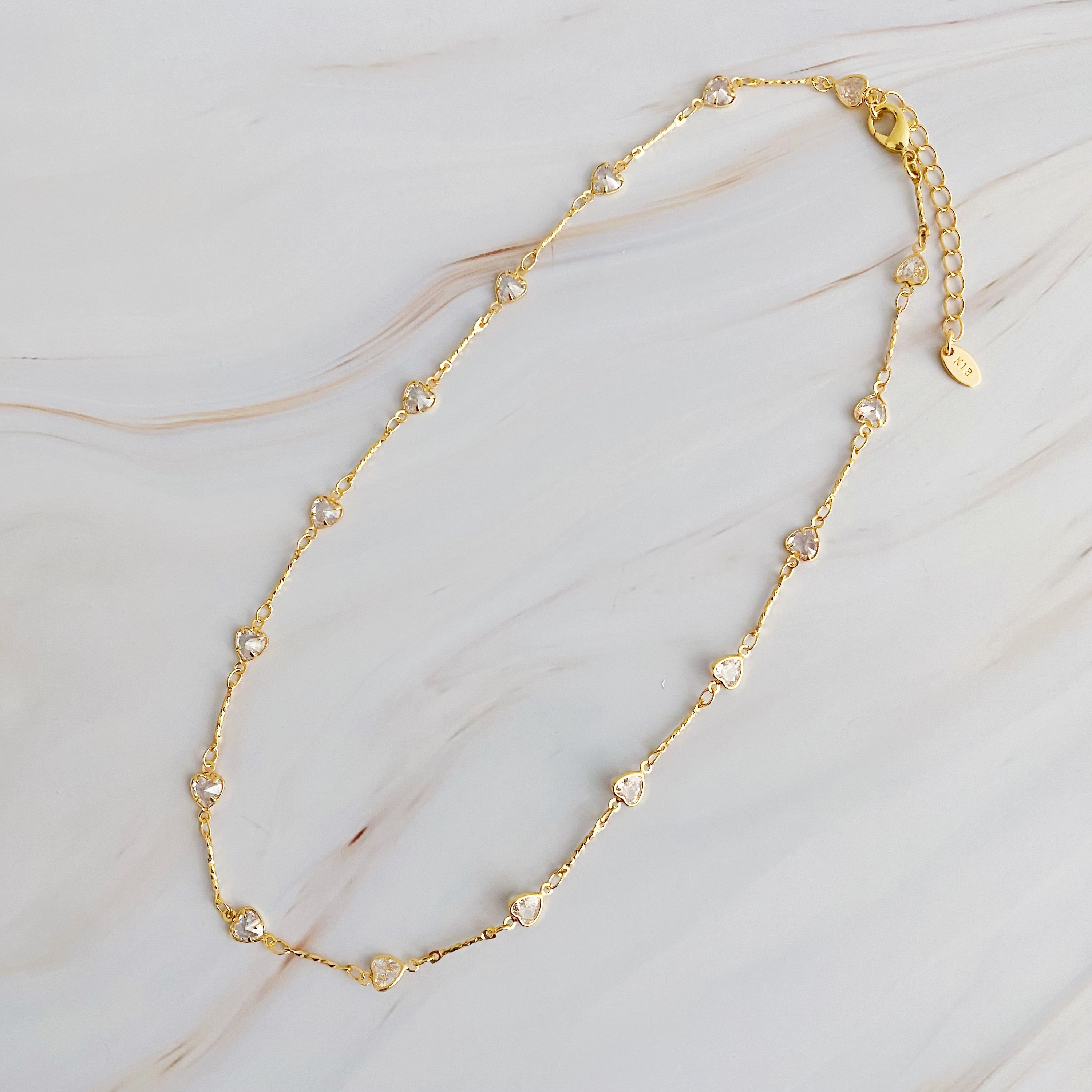 Oh My Shaped Sparkling Necklace featuring a star or heart design with cubic zirconia on a gold plated chain.