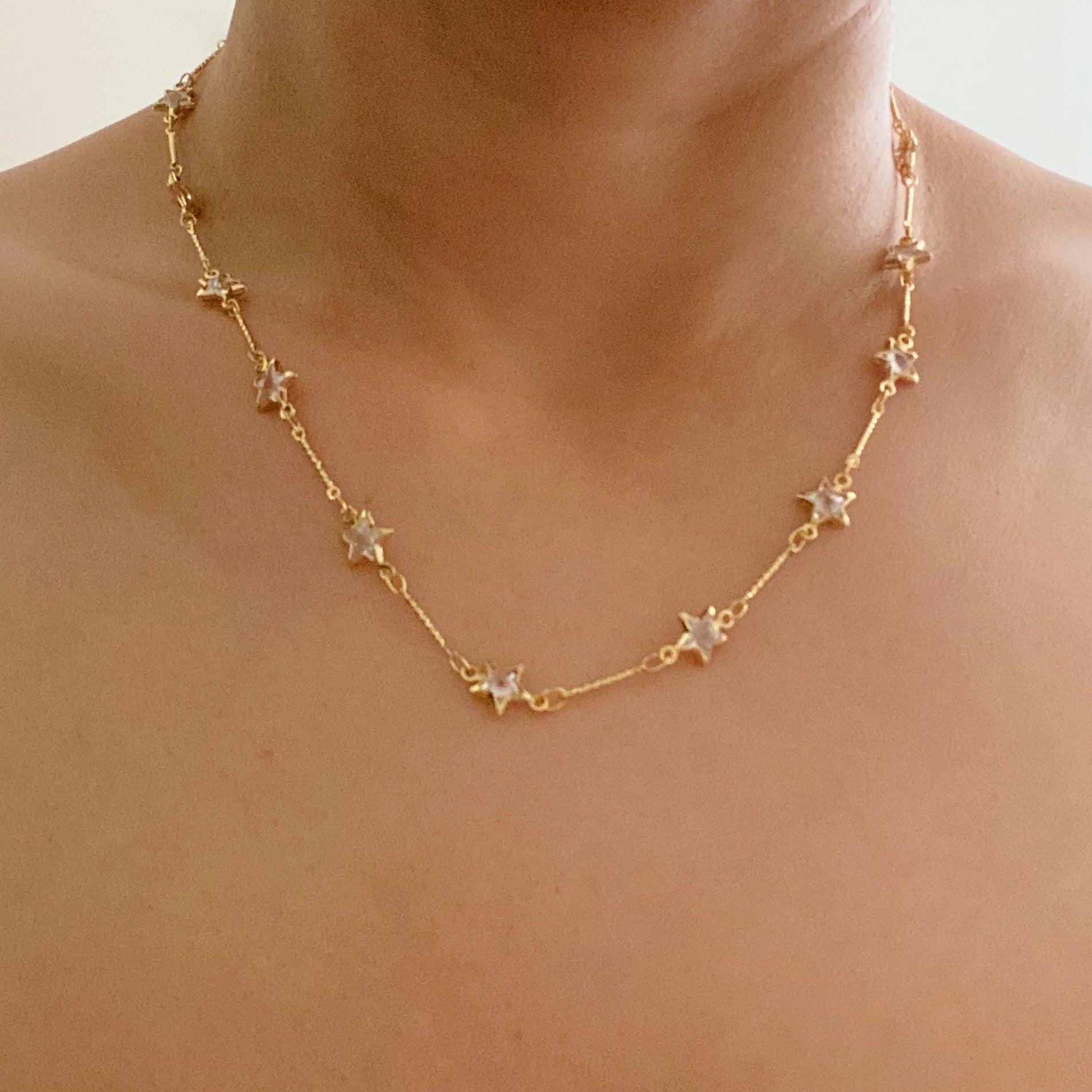 Oh My Shaped Sparkling Necklace featuring a star or heart design with cubic zirconia on a gold plated chain.