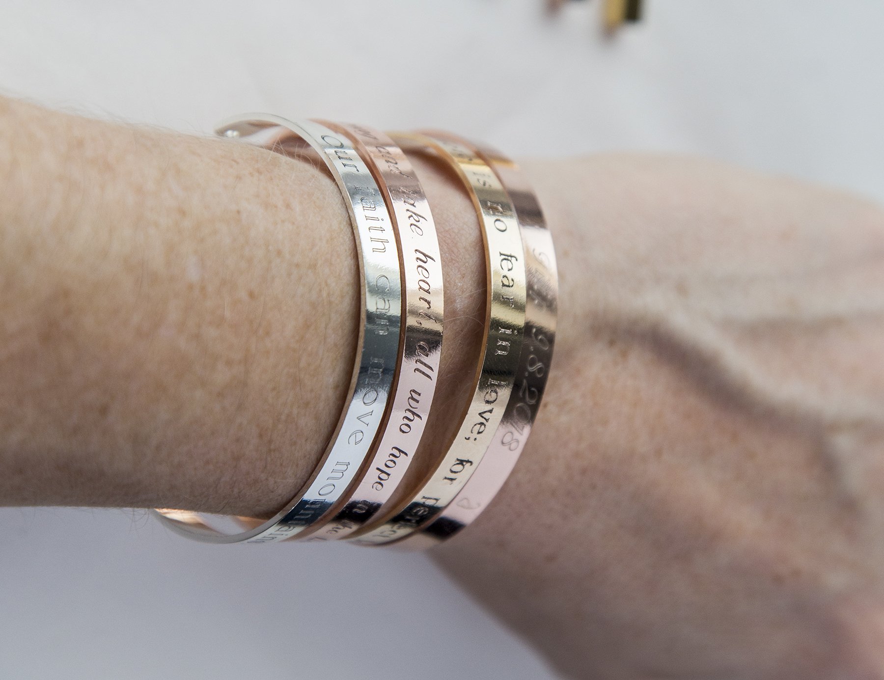 One Day at a Time Bracelet in gold, rose gold, and silver plating, showcasing its delicate design and motivational message.