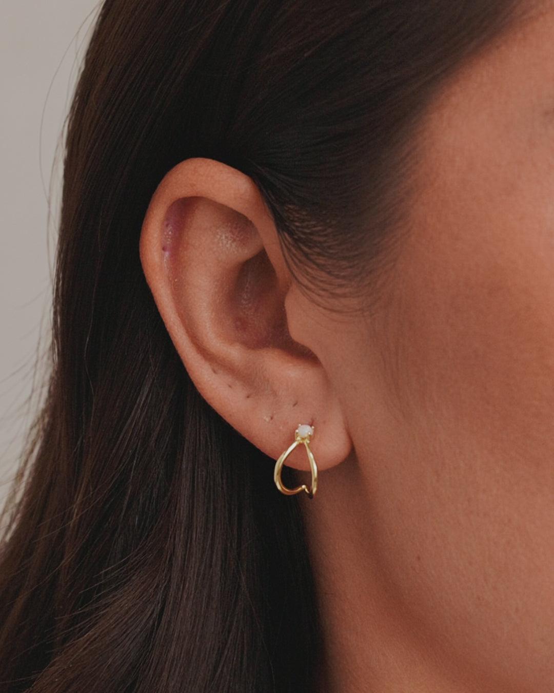 Opalite Solitaire Double Huggies in 14k gold, showcasing elegant opalite stones.