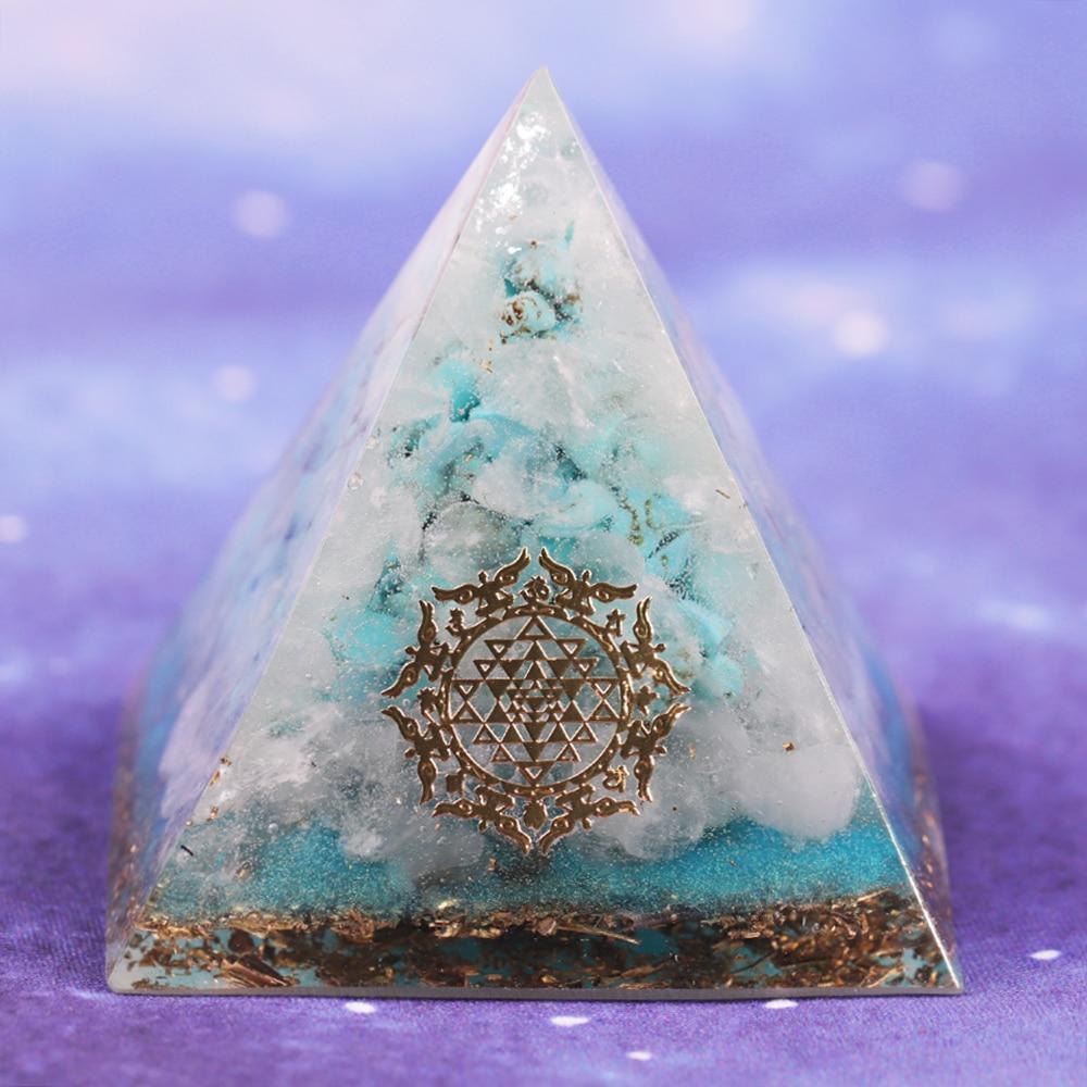 A handcrafted Orgone Crystal Gemstone Pyramid made of turquoise, white crystal, and copper scraps, designed for energy generation and home decor.