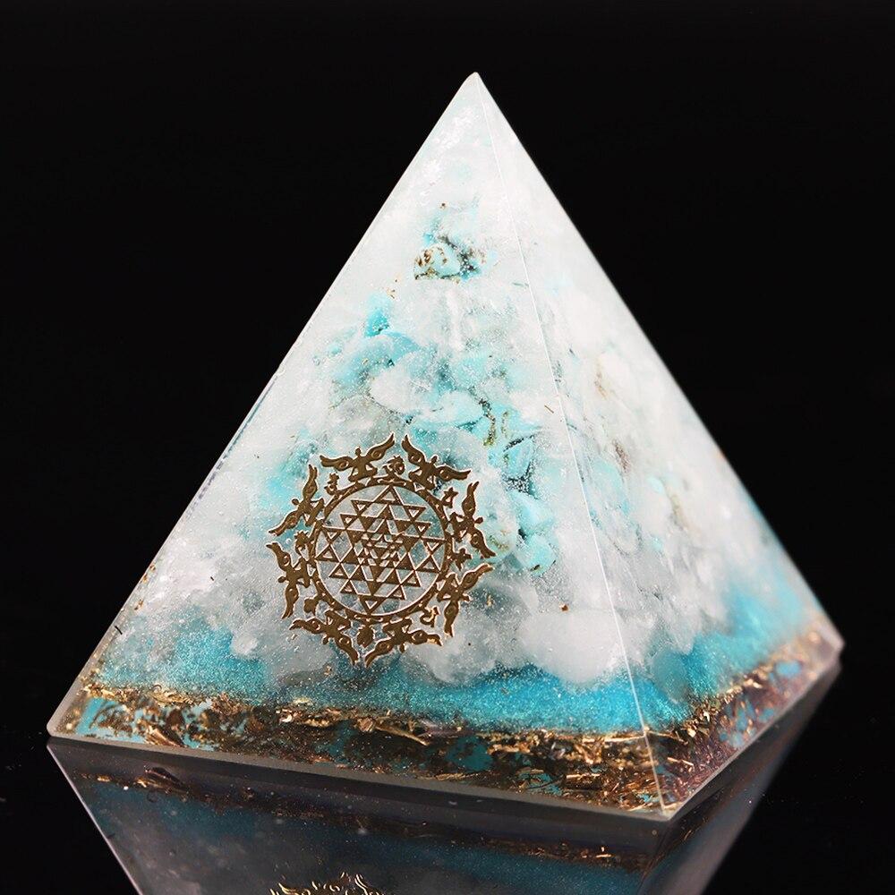 A handcrafted Orgone Crystal Gemstone Pyramid made of turquoise, white crystal, and copper scraps, designed for energy generation and home decor.