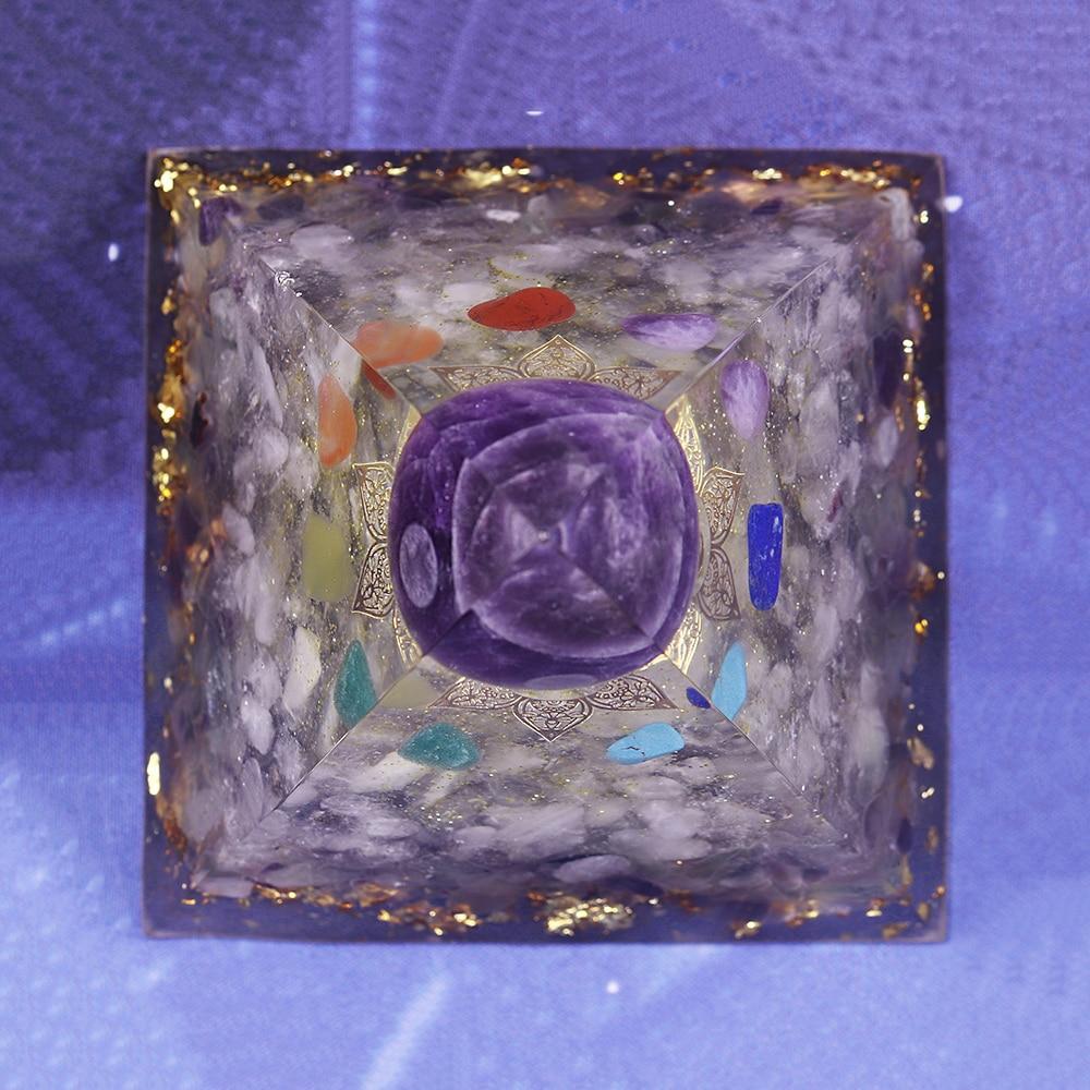 A beautifully handcrafted Orgonite Amethyst Pyramid featuring natural stones like amethyst and fluorite, designed to enhance energy flow.