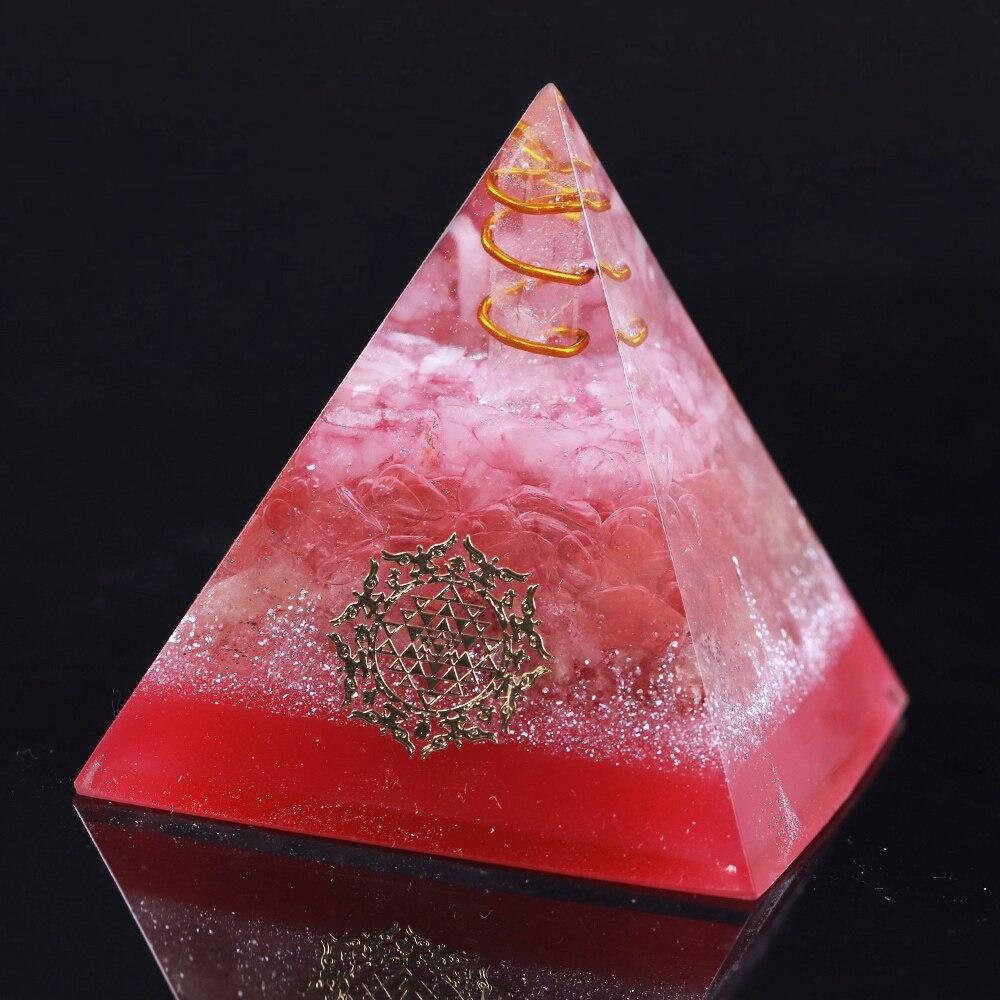 A handcrafted Orgonite Energy Generator Pyramid featuring a vibrant Strawberry Crystal, designed for EMF protection and meditation.