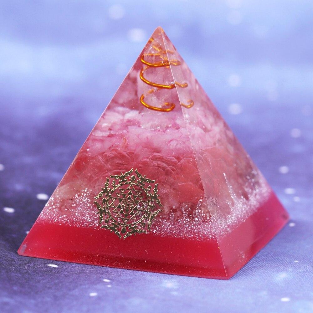A handcrafted Orgonite Energy Generator Pyramid featuring a vibrant Strawberry Crystal, designed for EMF protection and meditation.