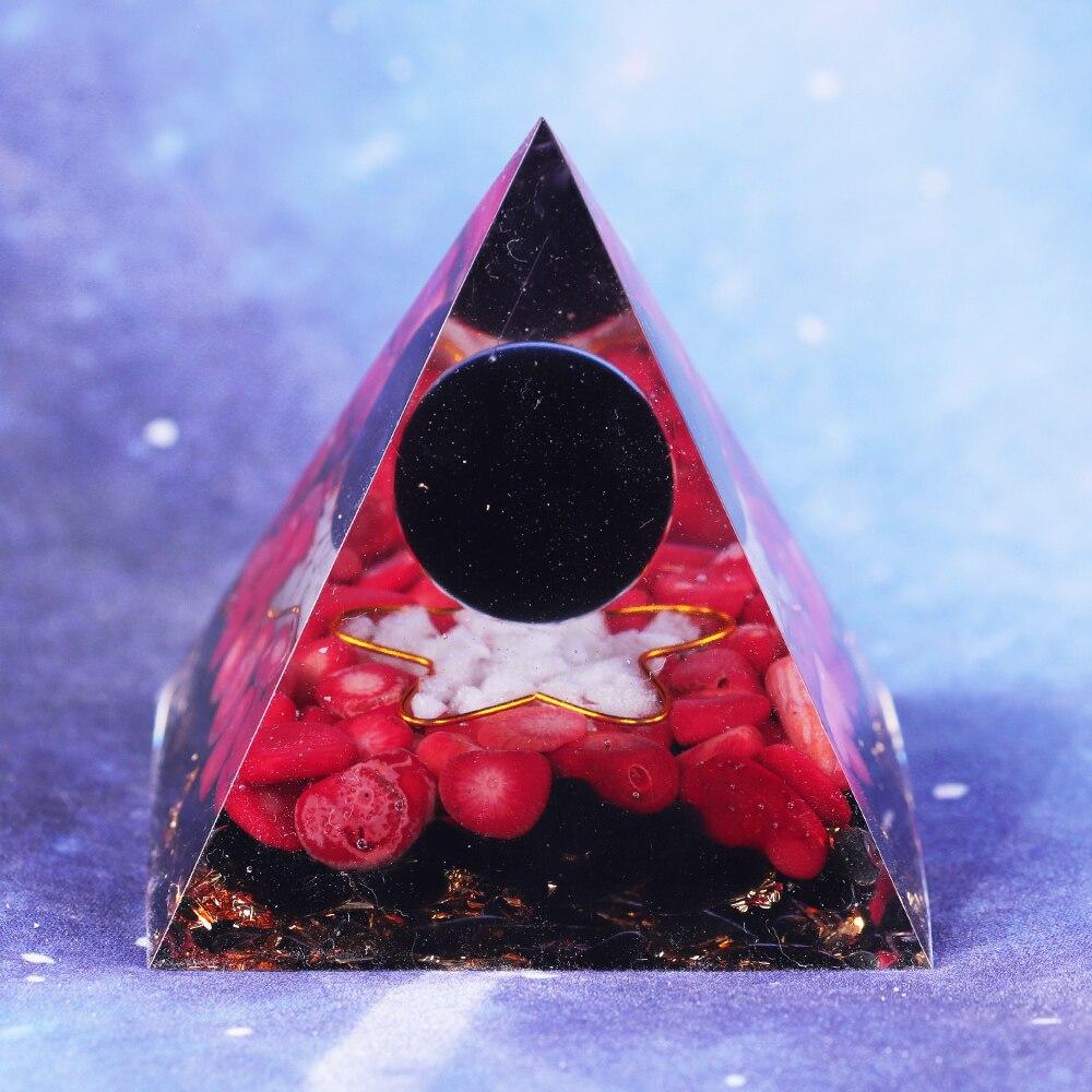 A handcrafted Orgonite pyramid made of natural obsidian, red coral, copper, and gold foil, designed for energy healing and meditation.