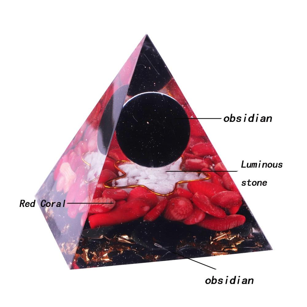 A handcrafted Orgonite pyramid made of natural obsidian, red coral, copper, and gold foil, designed for energy healing and meditation.