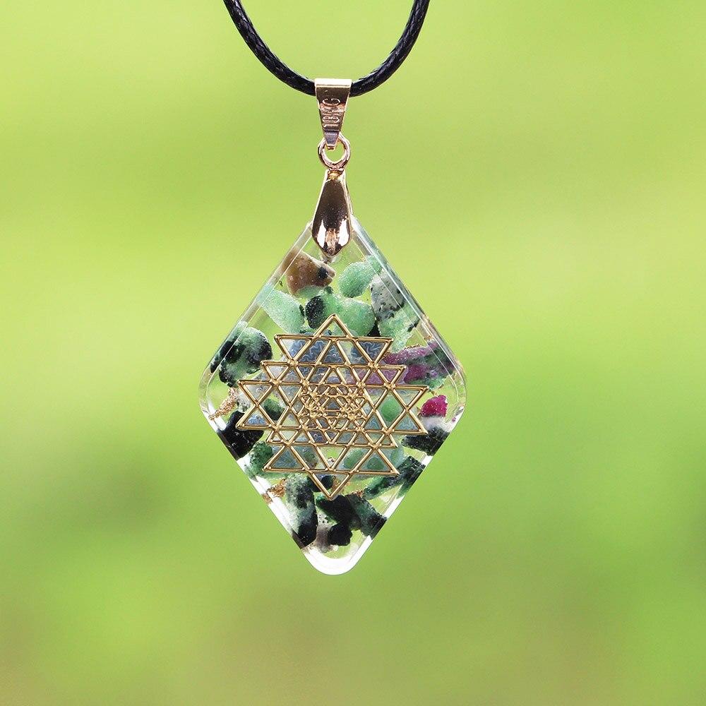 Handmade orgonite pendant featuring natural Epidote and gold foil in a geometric design, ideal for energy conversion and protection.