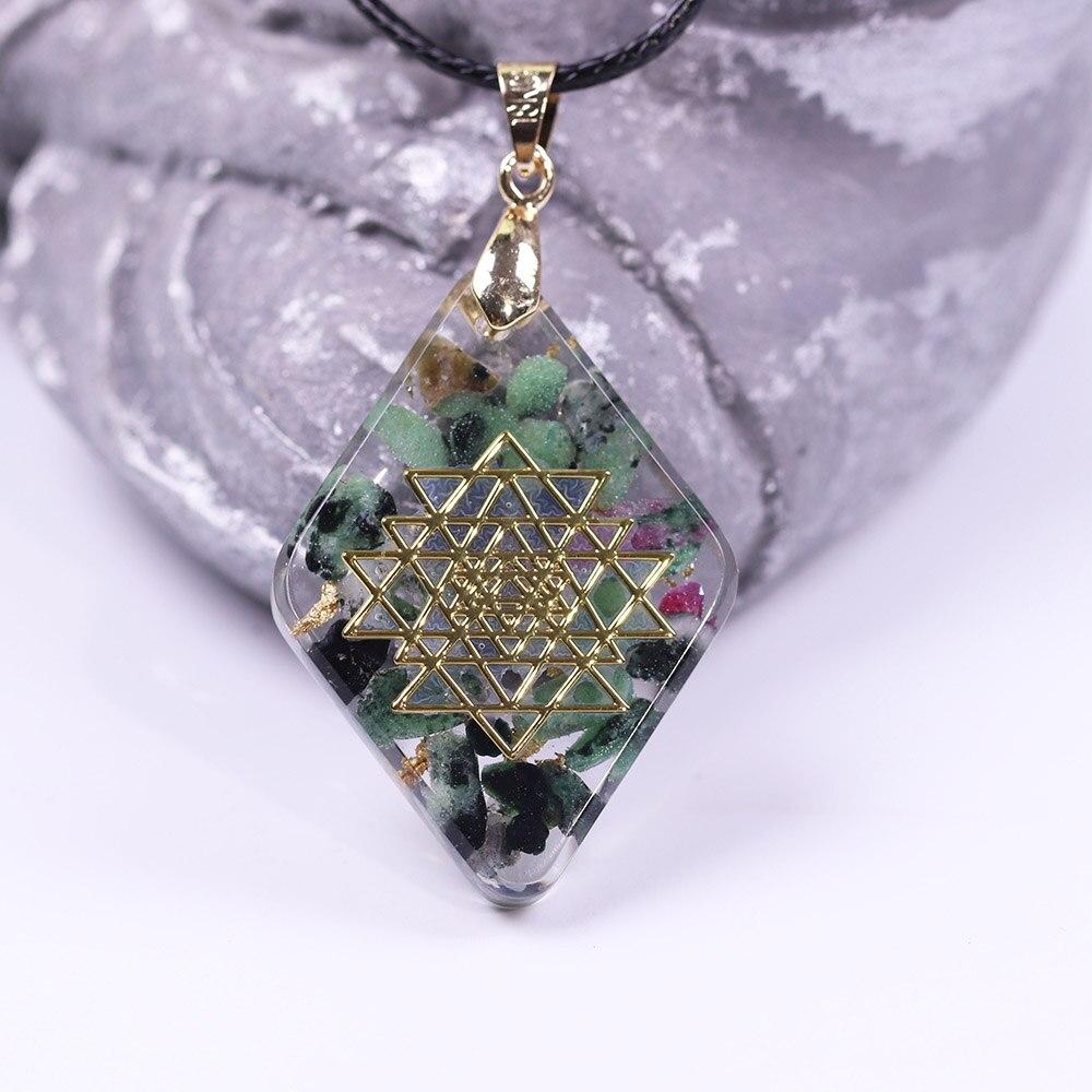 Handmade orgonite pendant featuring natural Epidote and gold foil in a geometric design, ideal for energy conversion and protection.