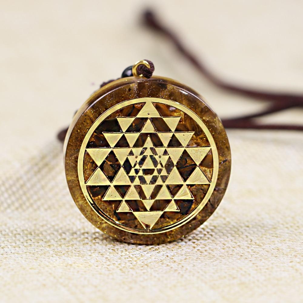 Handmade Orgonite Pendant featuring Sri Yantra sacred geometry and Tiger Eye stone, designed for meditation and protection.