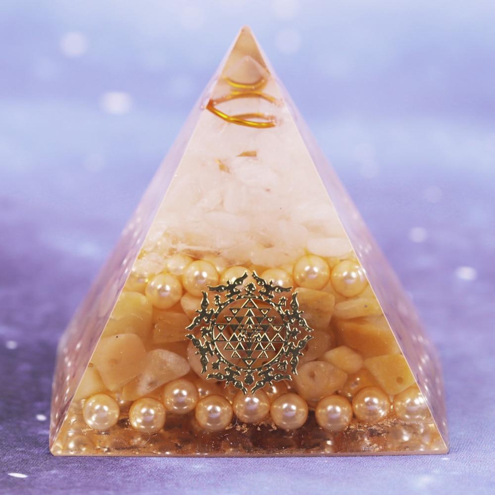Handcrafted Orgonite Pyramid made of white crystal, pearl, copper, and gold foil, designed for energy healing and chakra balancing.