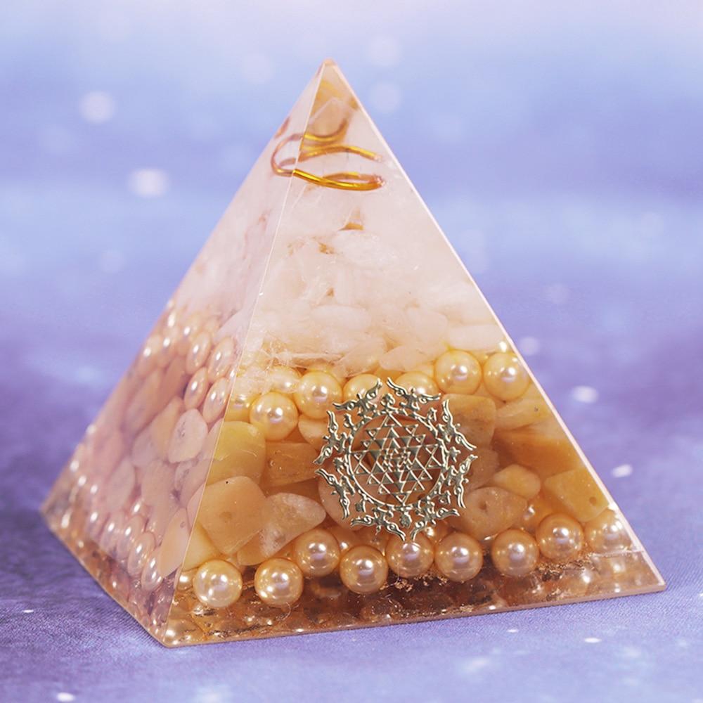 Handcrafted Orgonite Pyramid made of white crystal, pearl, copper, and gold foil, designed for energy healing and chakra balancing.