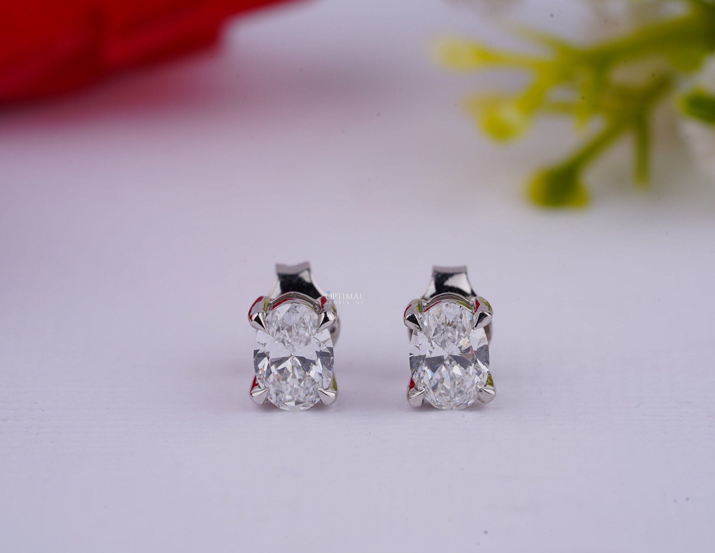 Elegant oval cut lab diamond earrings set in white gold, featuring IGI certification and a total carat weight of 1.00 Ctw.