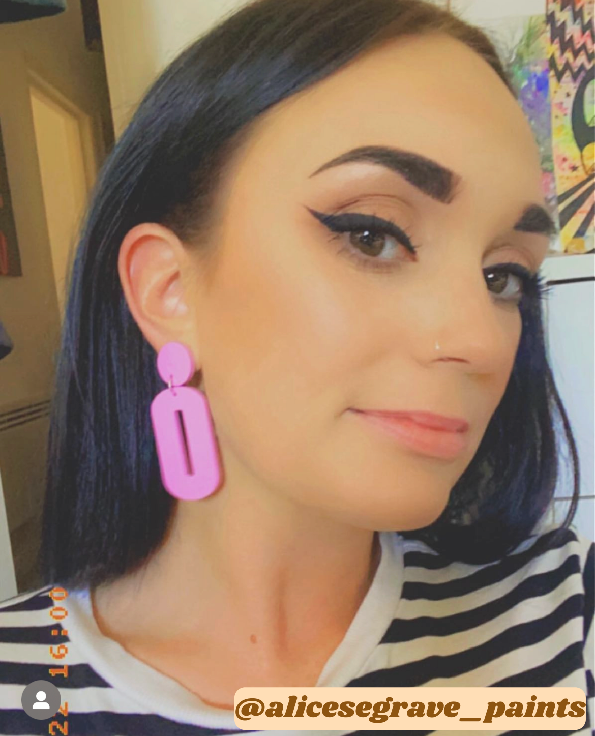 A pair of stylish oval drop earrings made from laser-cut acrylic, showcasing their elegant design and available colors.