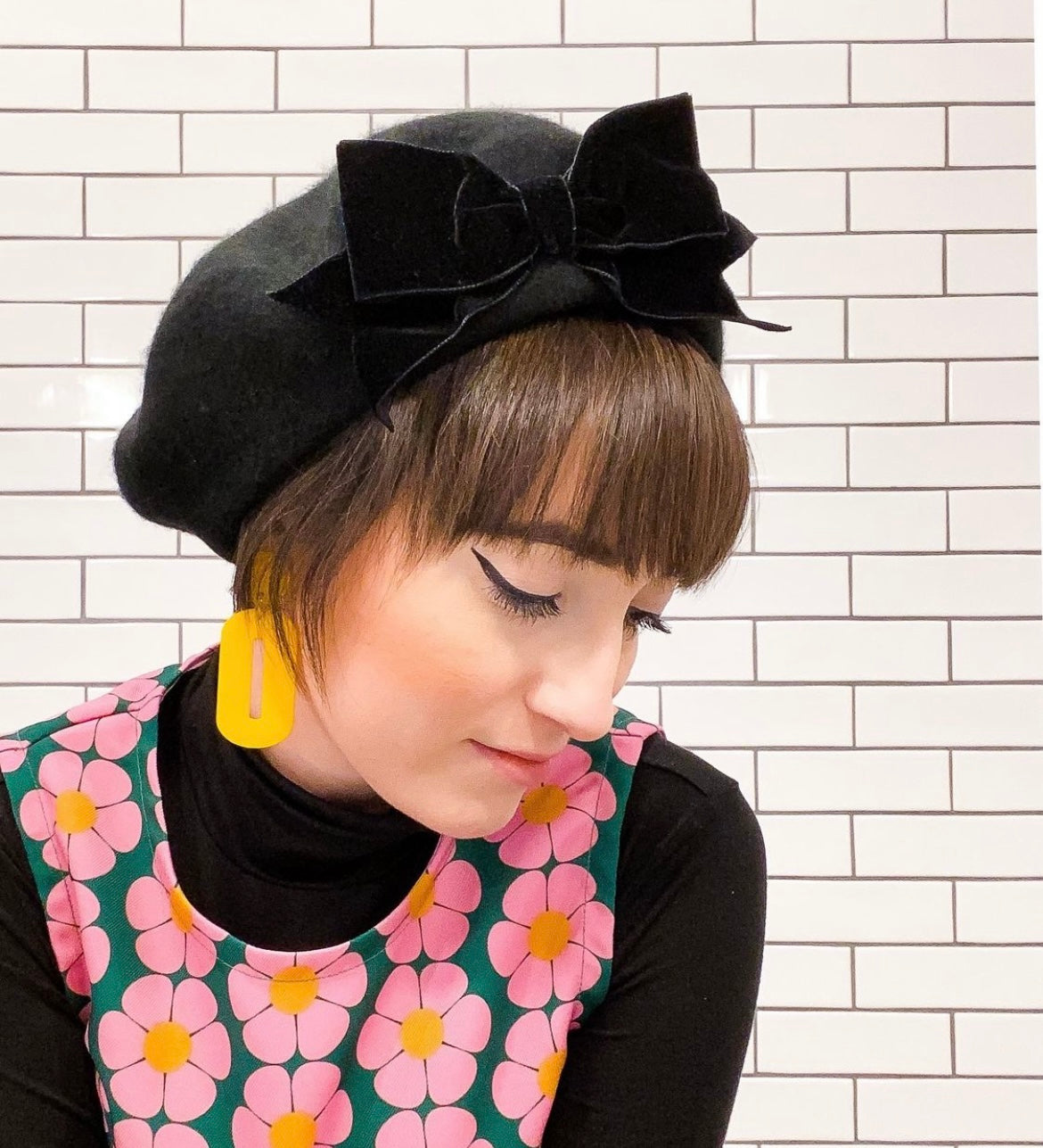 A pair of stylish oval drop earrings made from laser-cut acrylic, showcasing their elegant design and available colors.