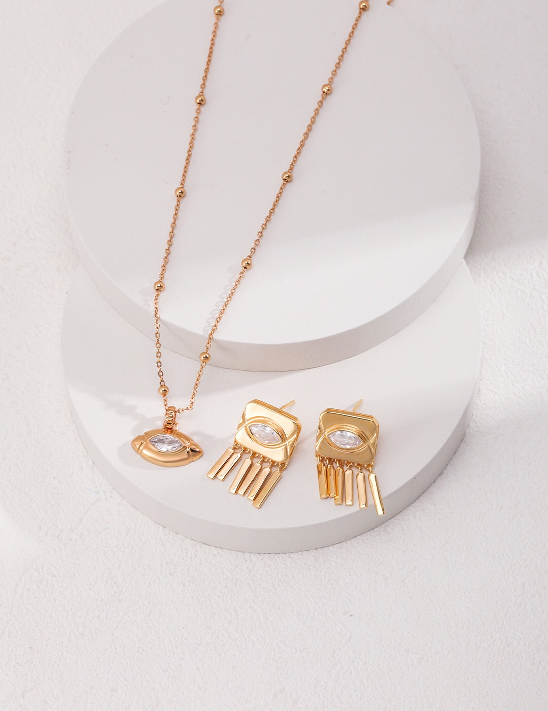 A stunning Oval Eyes Zircon Necklace featuring sparkling zircon stones set in gold vermeil, elegantly displayed on a soft background.