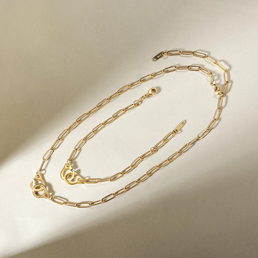 A stylish Paper Clip Link Bracelet made of 316L surgical stainless steel with a 14K gold PVD plated finish, showcasing its elegant design.