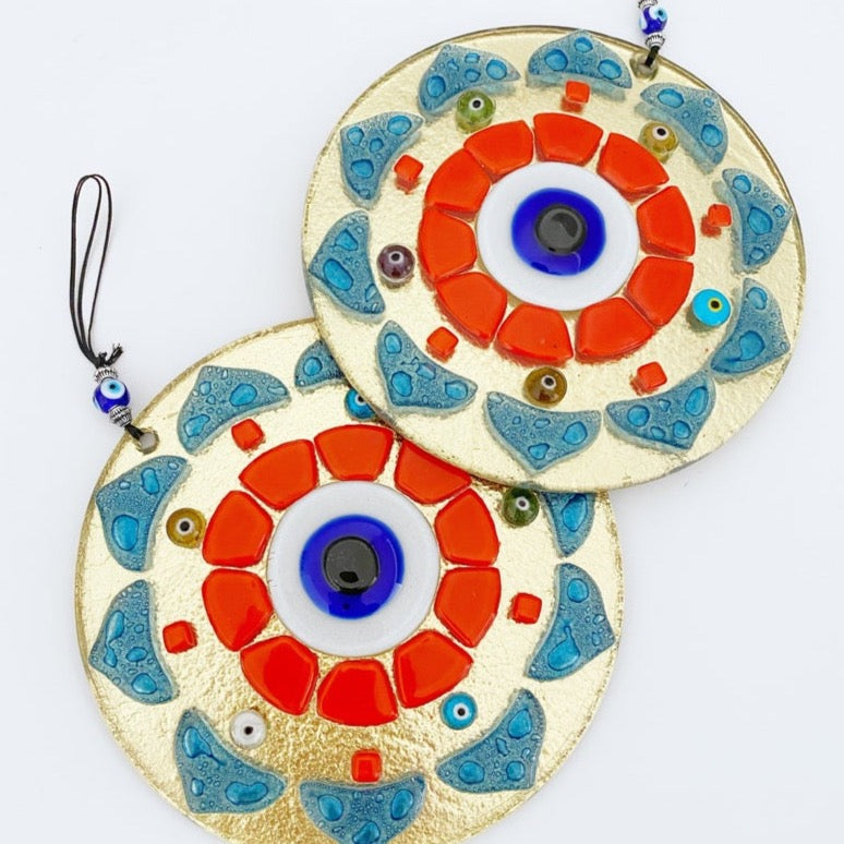 Handmade orange patterned evil eye wall hanging made of glass, featuring unique designs and vibrant colors, perfect for home decor.