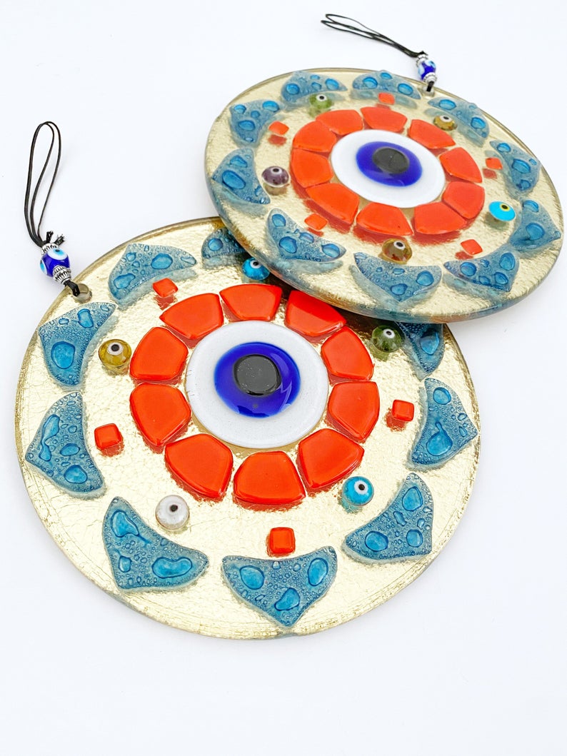 Handmade orange patterned evil eye wall hanging made of glass, featuring unique designs and vibrant colors, perfect for home decor.