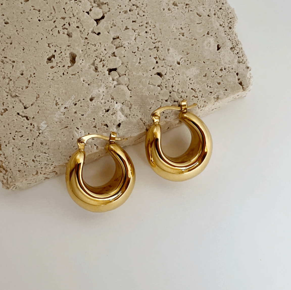 Pattie Chunky Polished Gold Creole Earrings showcasing a unique polished design, lightweight structure, and elegant gold finish.