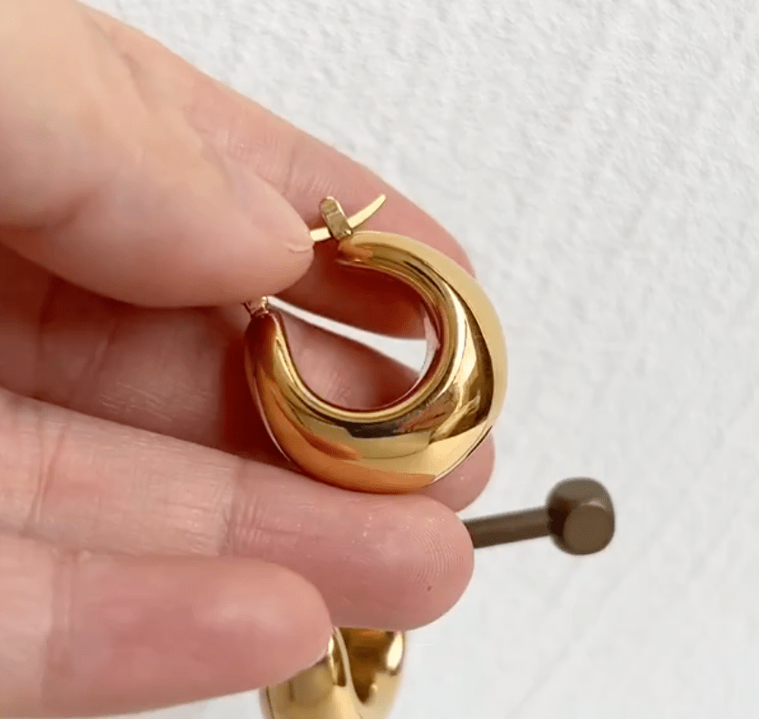 Pattie Chunky Polished Gold Creole Earrings showcasing a unique polished design, lightweight structure, and elegant gold finish.