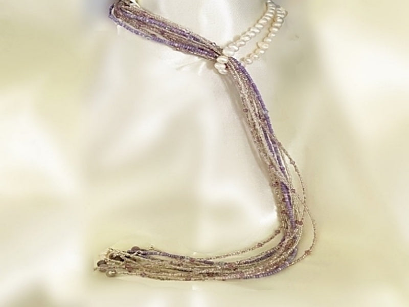 A beautiful Pearl and Lilac Jade Lariat Necklace featuring freshwater pearls, lilac jade, and a faux rhinestone heart button, elegantly displayed.