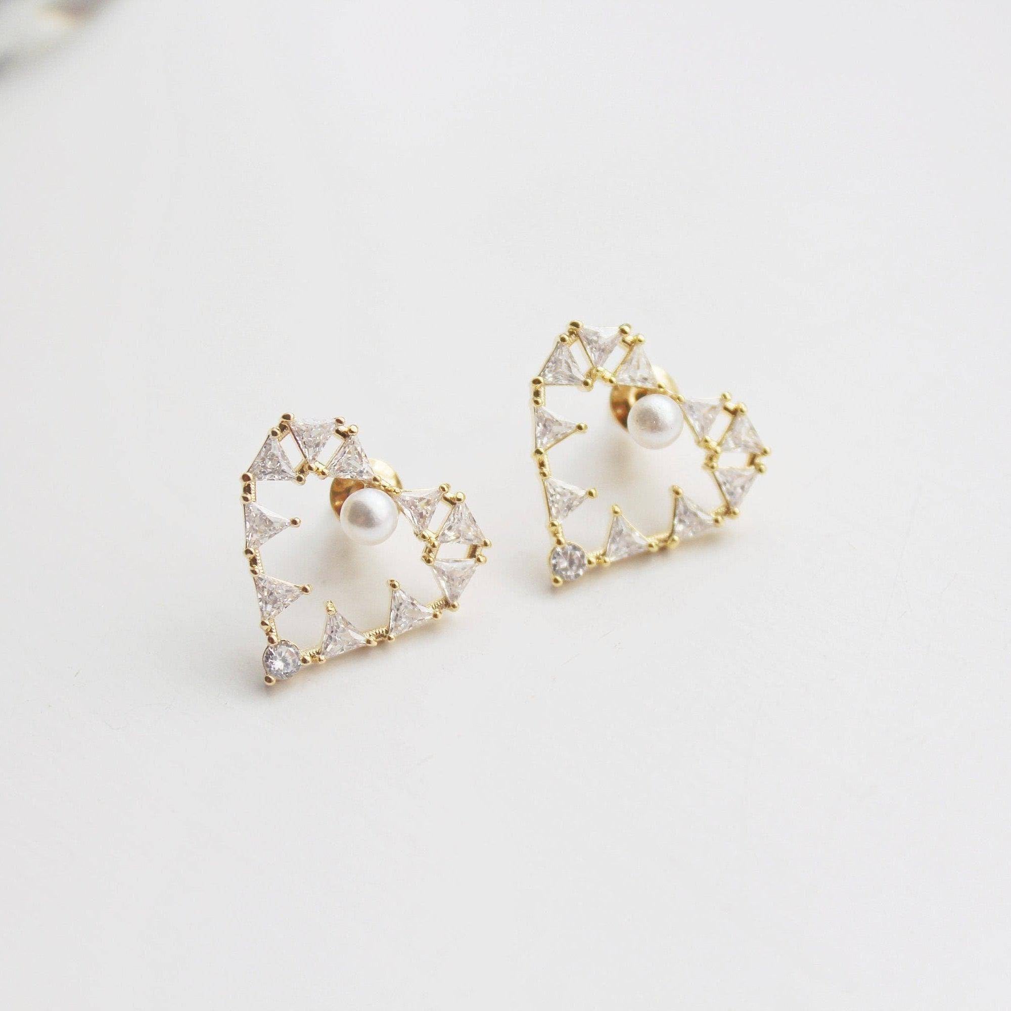 Elegant Pearl in Heart Earrings featuring triangle crystals set in a gold heart design, showcasing their luxurious appeal.
