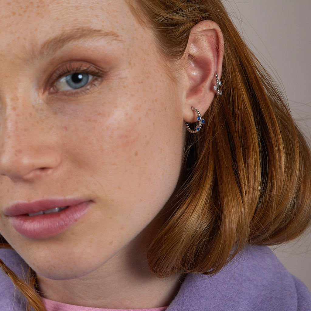 Pendientes aro de plata con tres circonitas azules brillantes, elegantes y sofisticados, perfectos para cualquier ocasión.