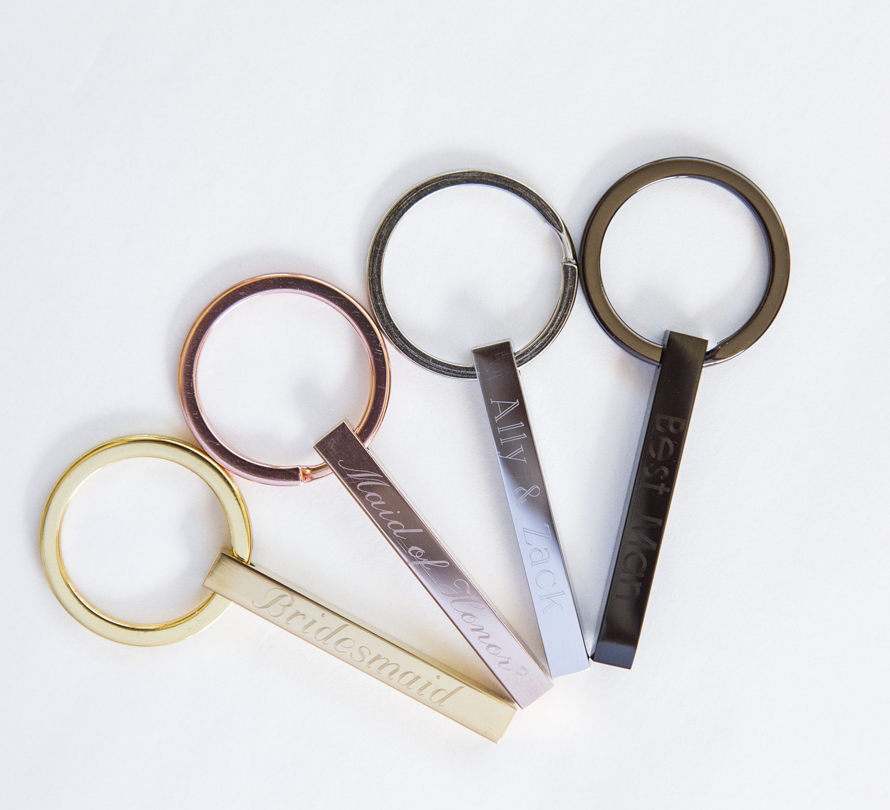 Personalized engraved stainless steel keychain with custom text on all sides, showcasing its compact design and high-quality finish.