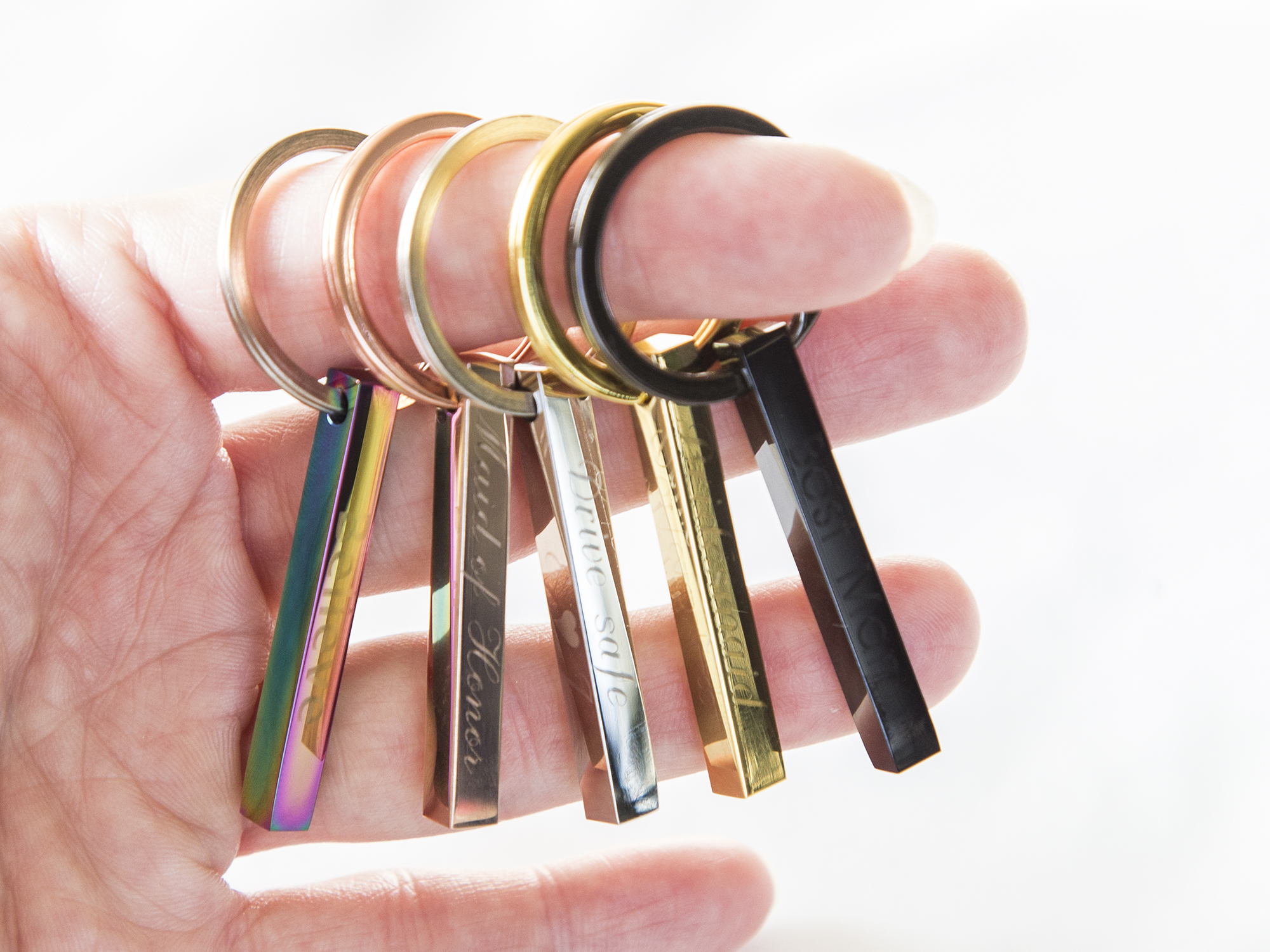 Personalized engraved stainless steel keychain with custom text on all sides, showcasing its compact design and high-quality finish.