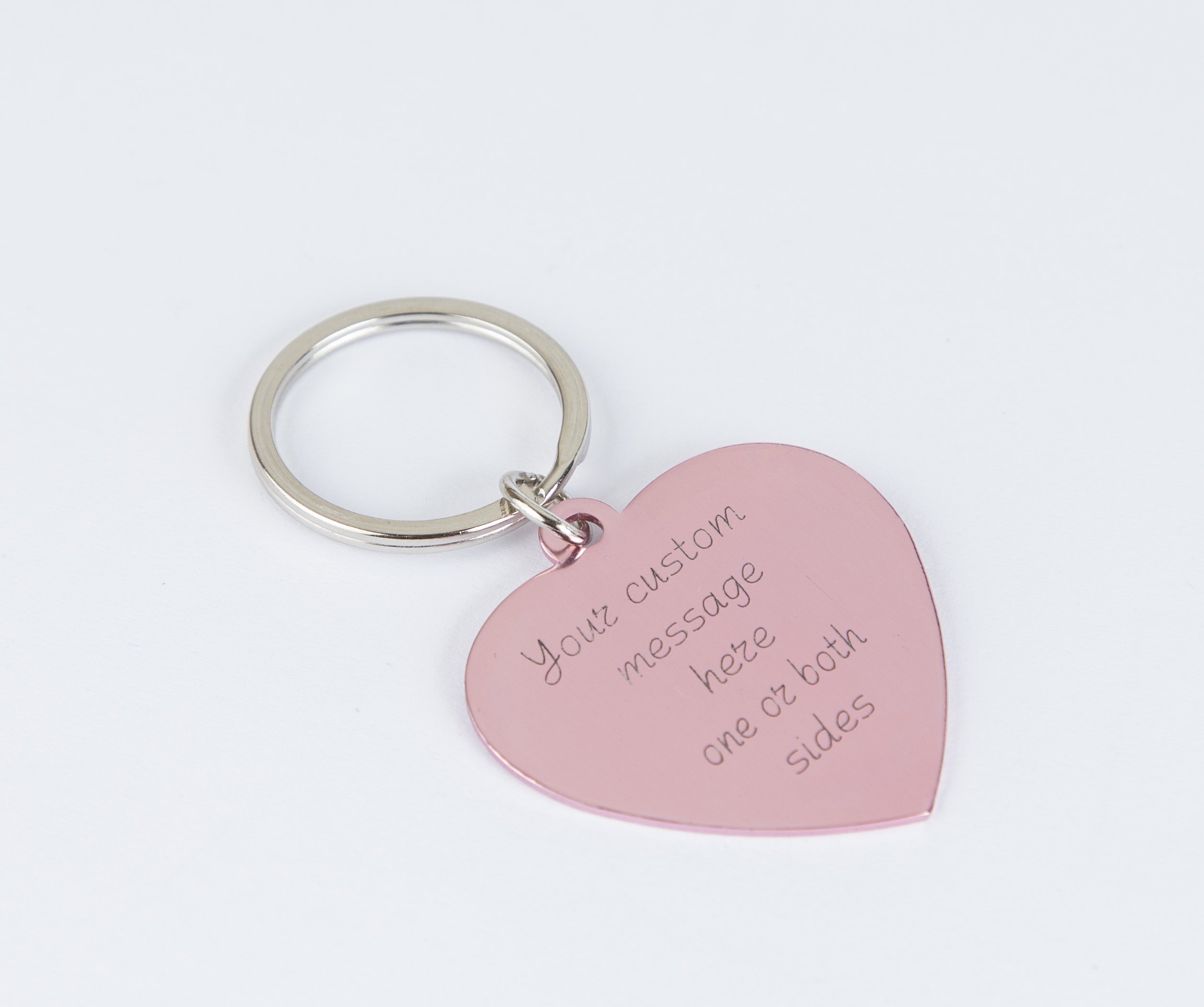 Personalized engraved pink heart keychain with a stainless steel keyring and lightweight aluminum tag, showcasing custom engraving options.
