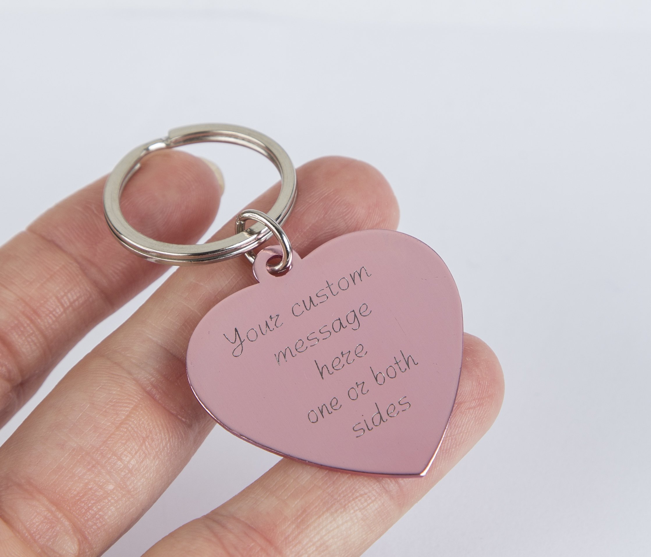 Personalized engraved pink heart keychain with a stainless steel keyring and lightweight aluminum tag, showcasing custom engraving options.