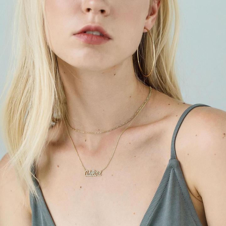 A beautiful personalized name necklace made of 925 sterling silver, featuring adjustable chain and available in multiple finishes.