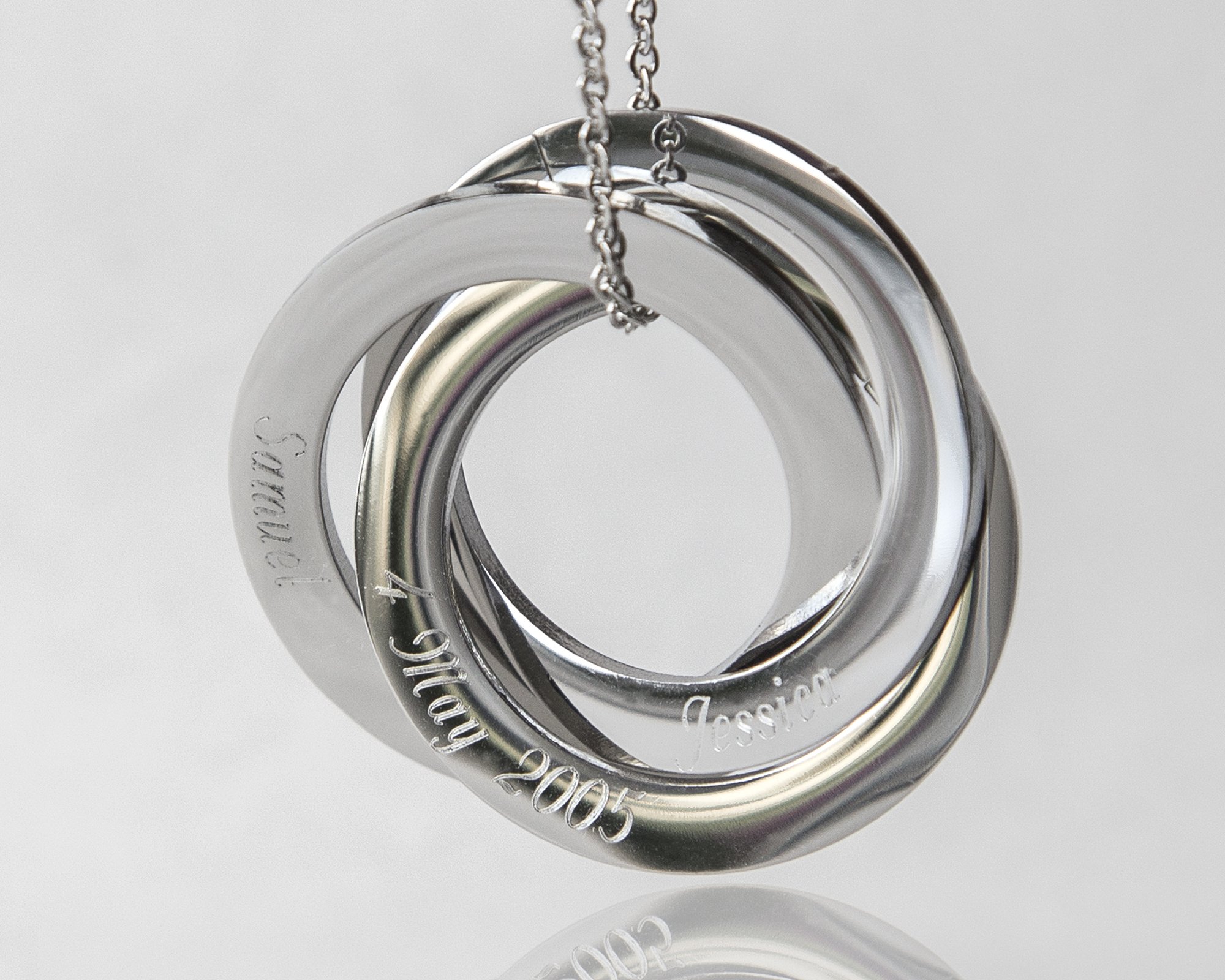 Personalized Rings Name Necklace featuring interlocked stainless steel rings with custom engravings.