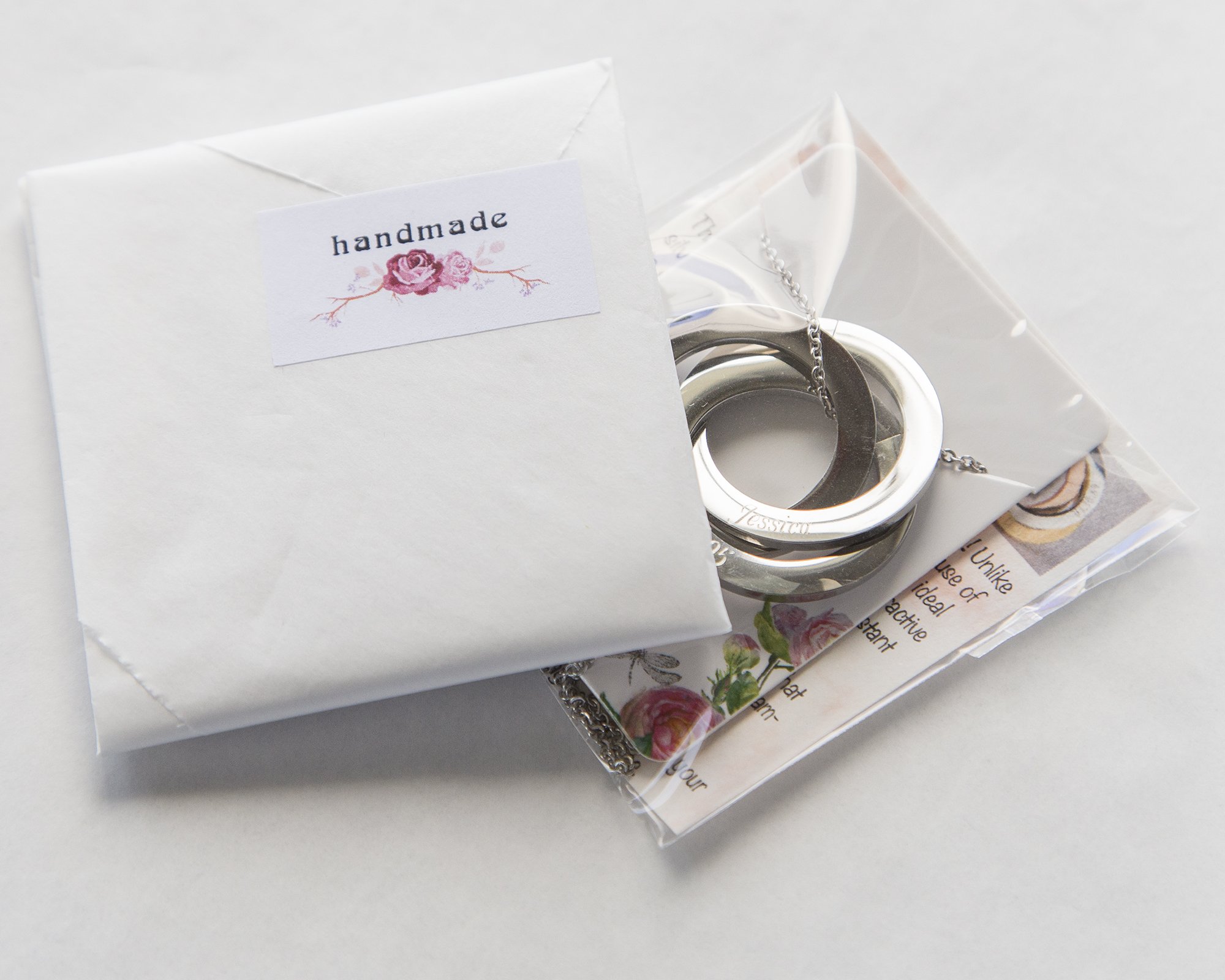 Personalized Rings Name Necklace featuring interlocked stainless steel rings with custom engravings.