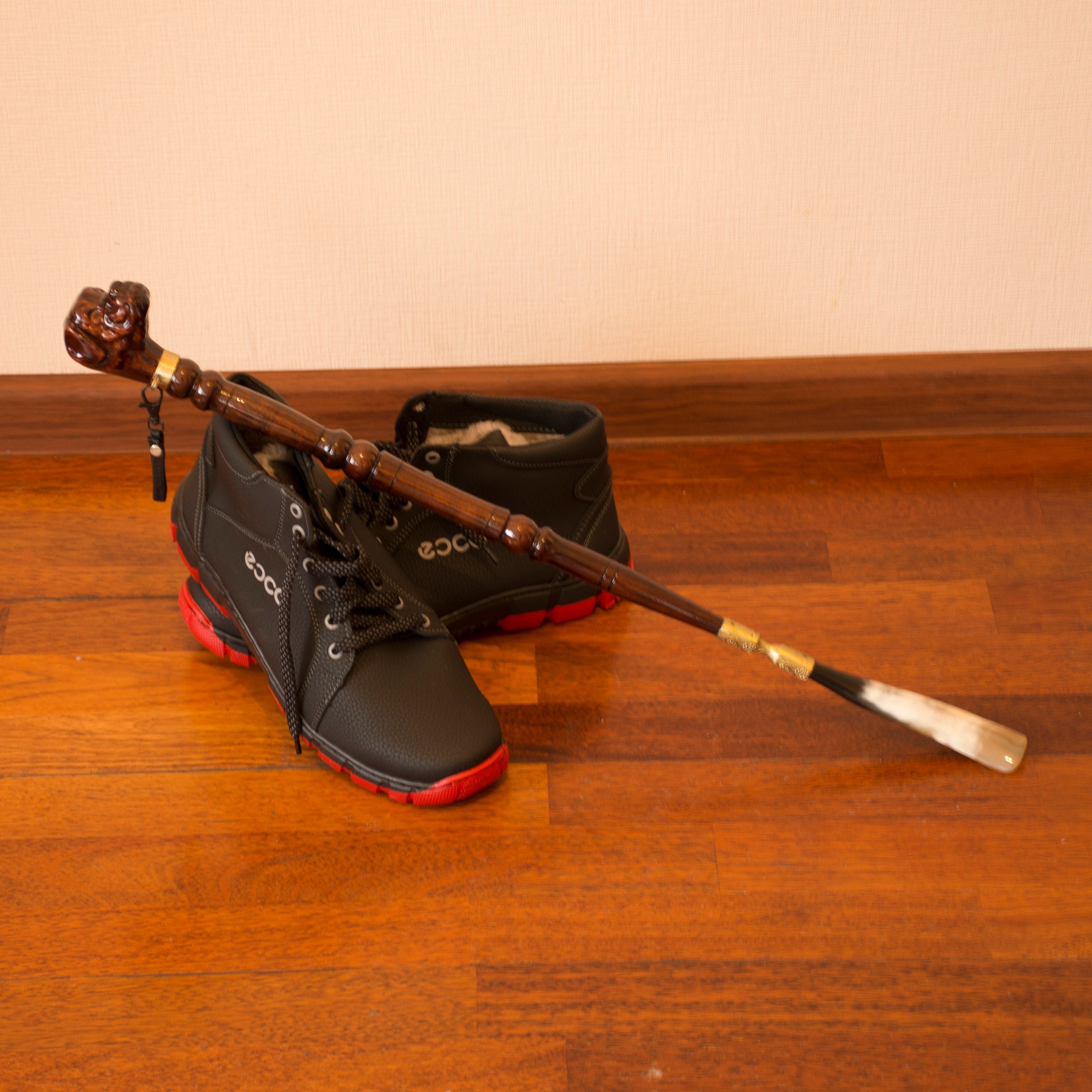 Personalized 28.5-inch wooden shoe horn with a boxer dog head design, crafted from high-quality materials including wood, brass, and leather.