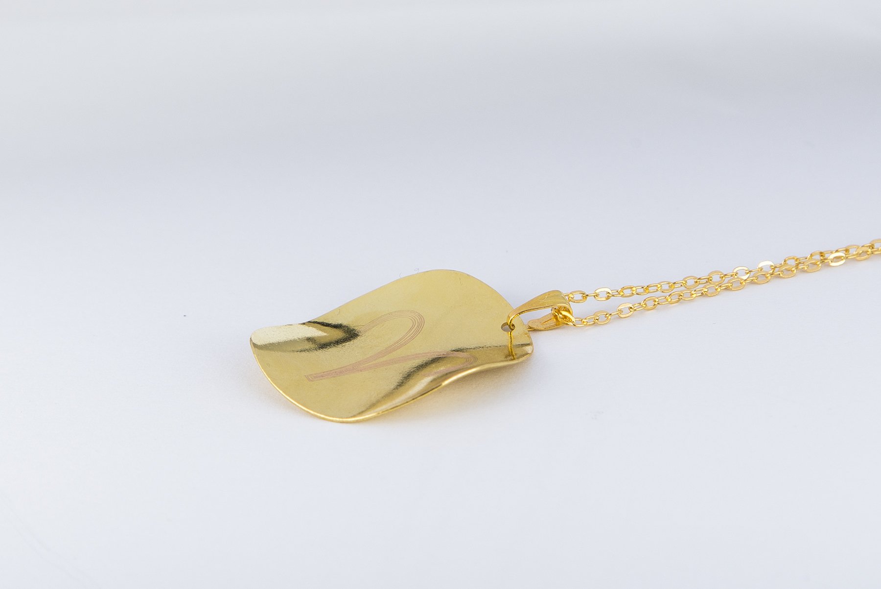 Personalized Zodiac Symbol Pendant in gold plating, featuring a twisted design and attached to a stainless steel necklace.