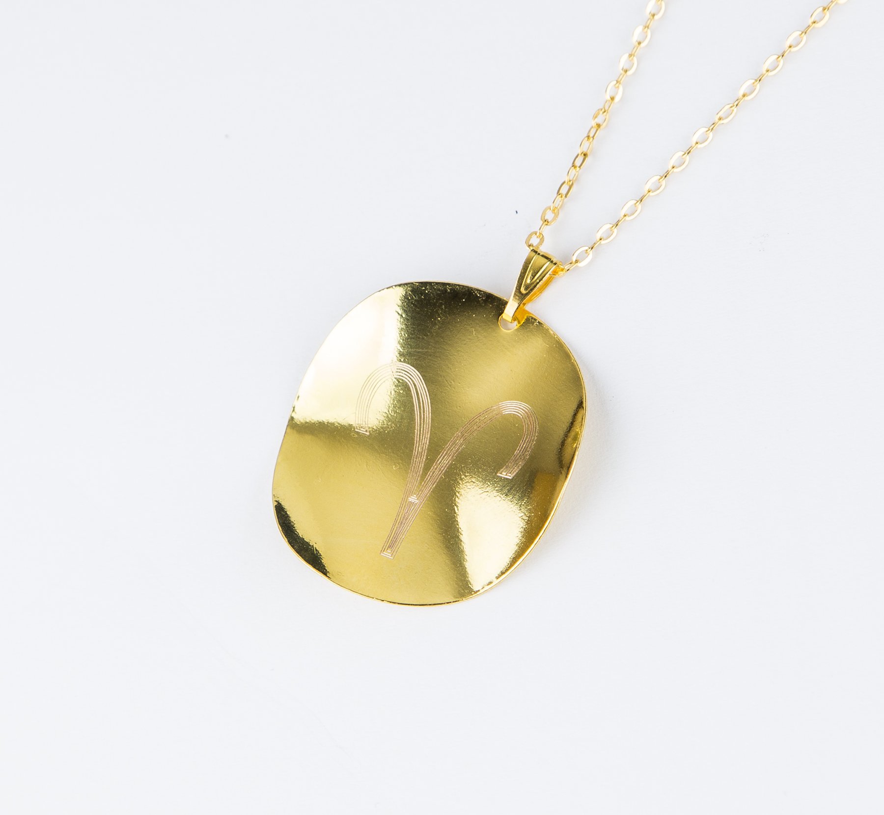 Personalized Zodiac Symbol Pendant in gold plating, featuring a twisted design and attached to a stainless steel necklace.