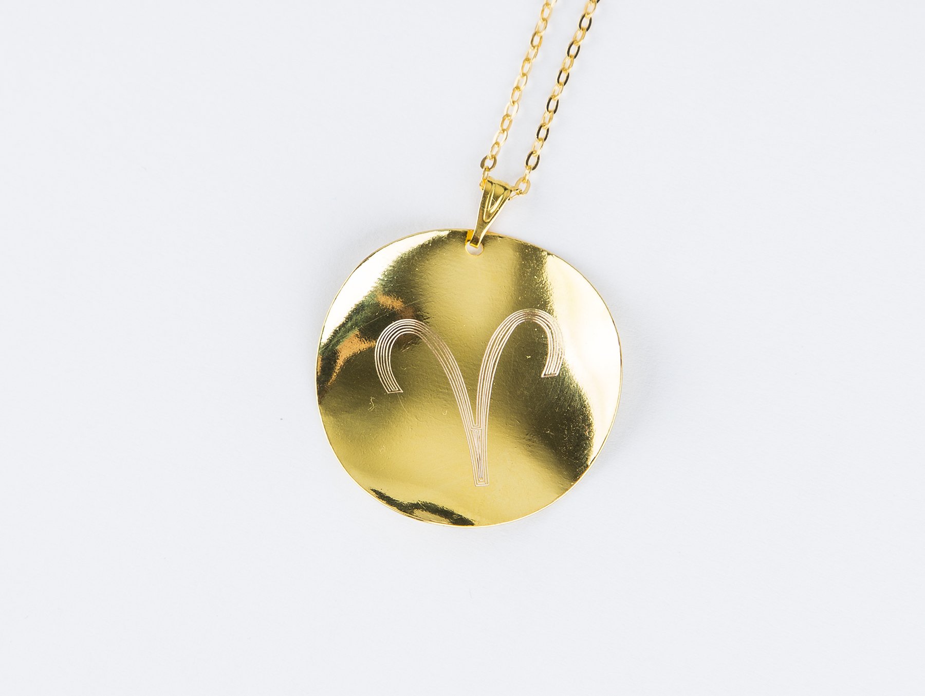 Personalized Zodiac Symbol Pendant in gold plating, featuring a twisted design and attached to a stainless steel necklace.