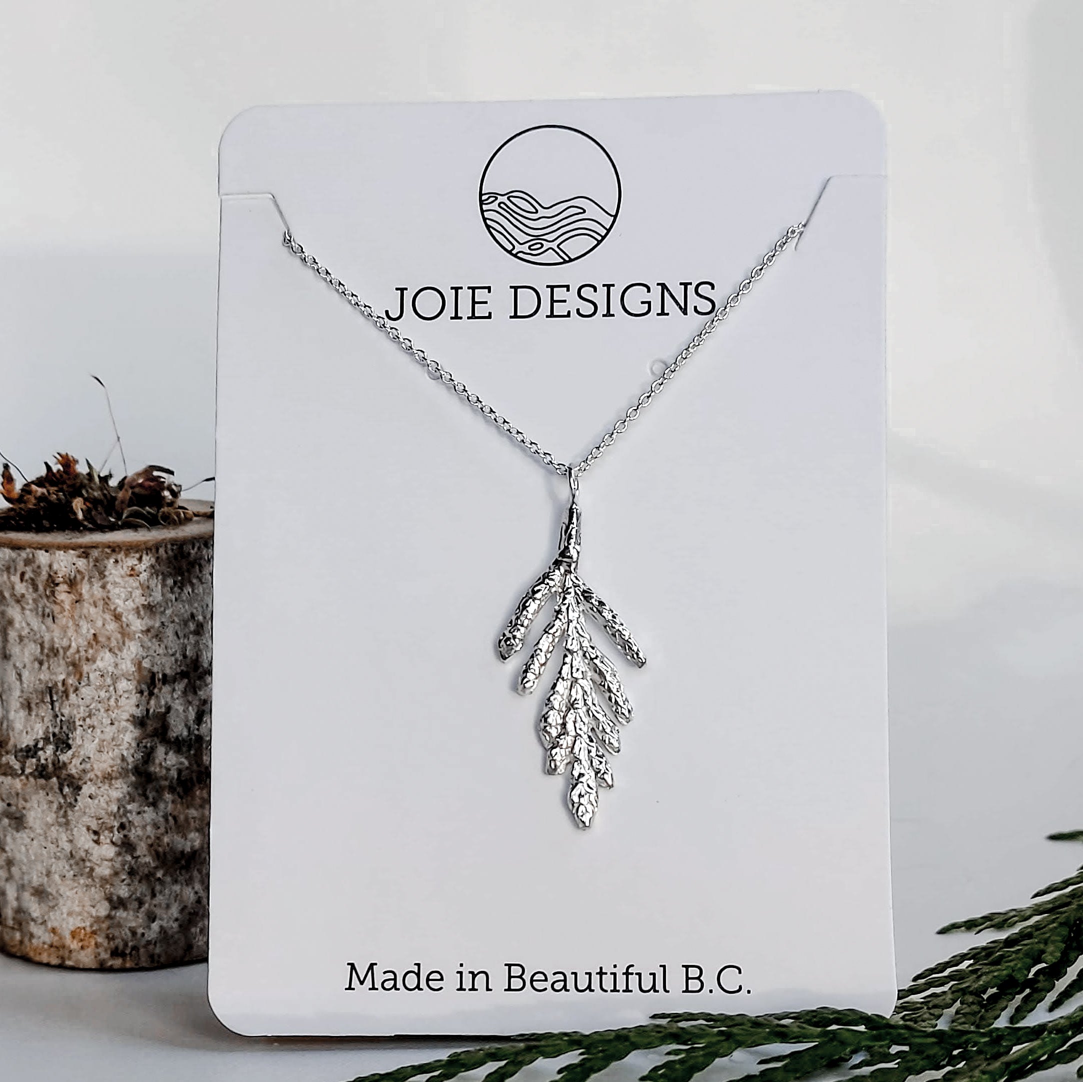 Petite Arborvitae Cedar Necklace featuring a detailed cedar leaf cast in sterling silver, showcasing its intricate design and natural beauty.