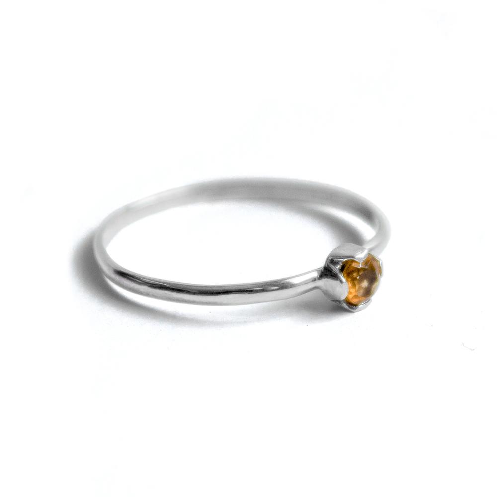A delicate Petite Citrine Solitaire Ring featuring a round citrine gemstone set in a unique castle setting, crafted from 925 sterling silver.