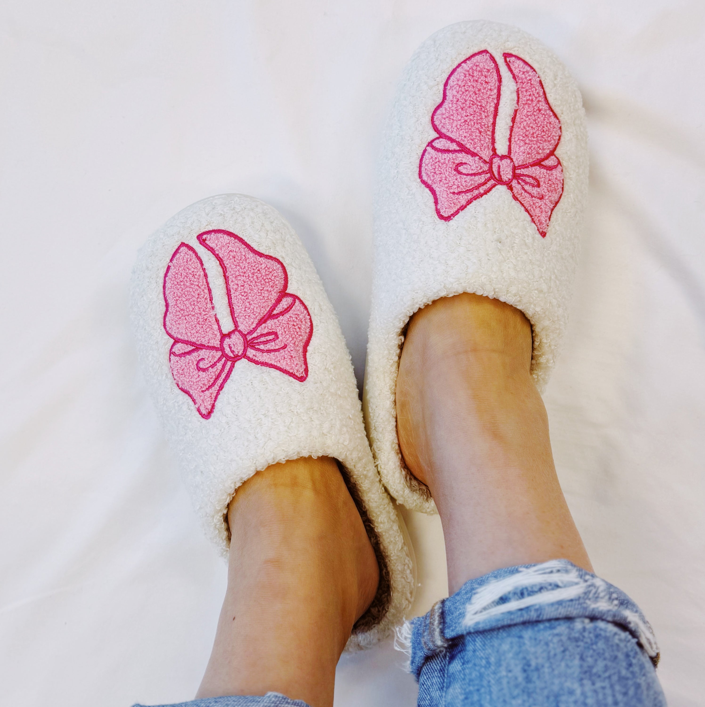 Pink Lounge Bow Cozy Slippers featuring a soft fabric and stylish bow accents, perfect for home lounging.