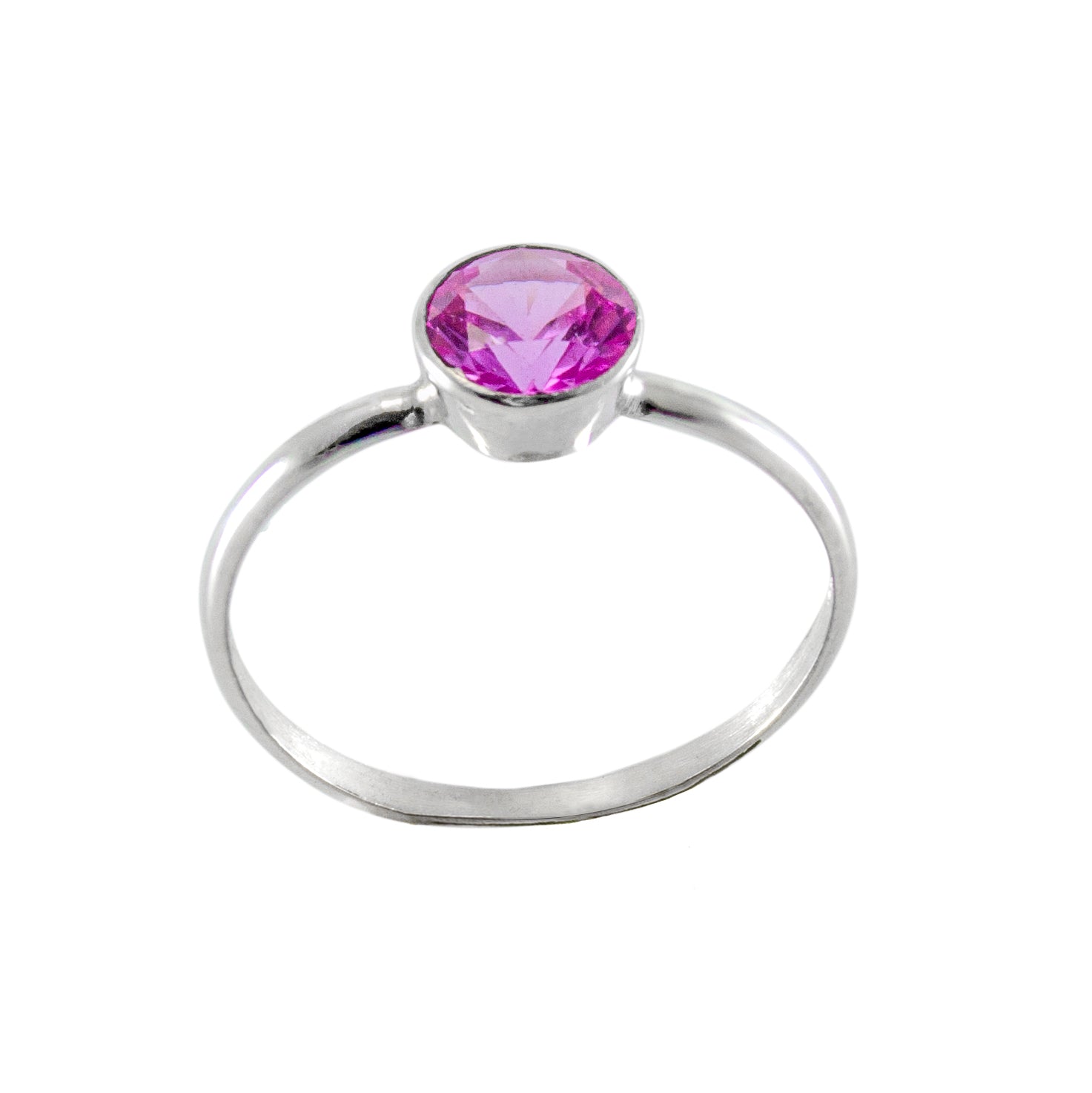 A beautiful Pink Sapphire Bezel Sterling Silver Ring featuring a round brilliant cut pink sapphire set in a sleek bezel setting on a tapered band.
